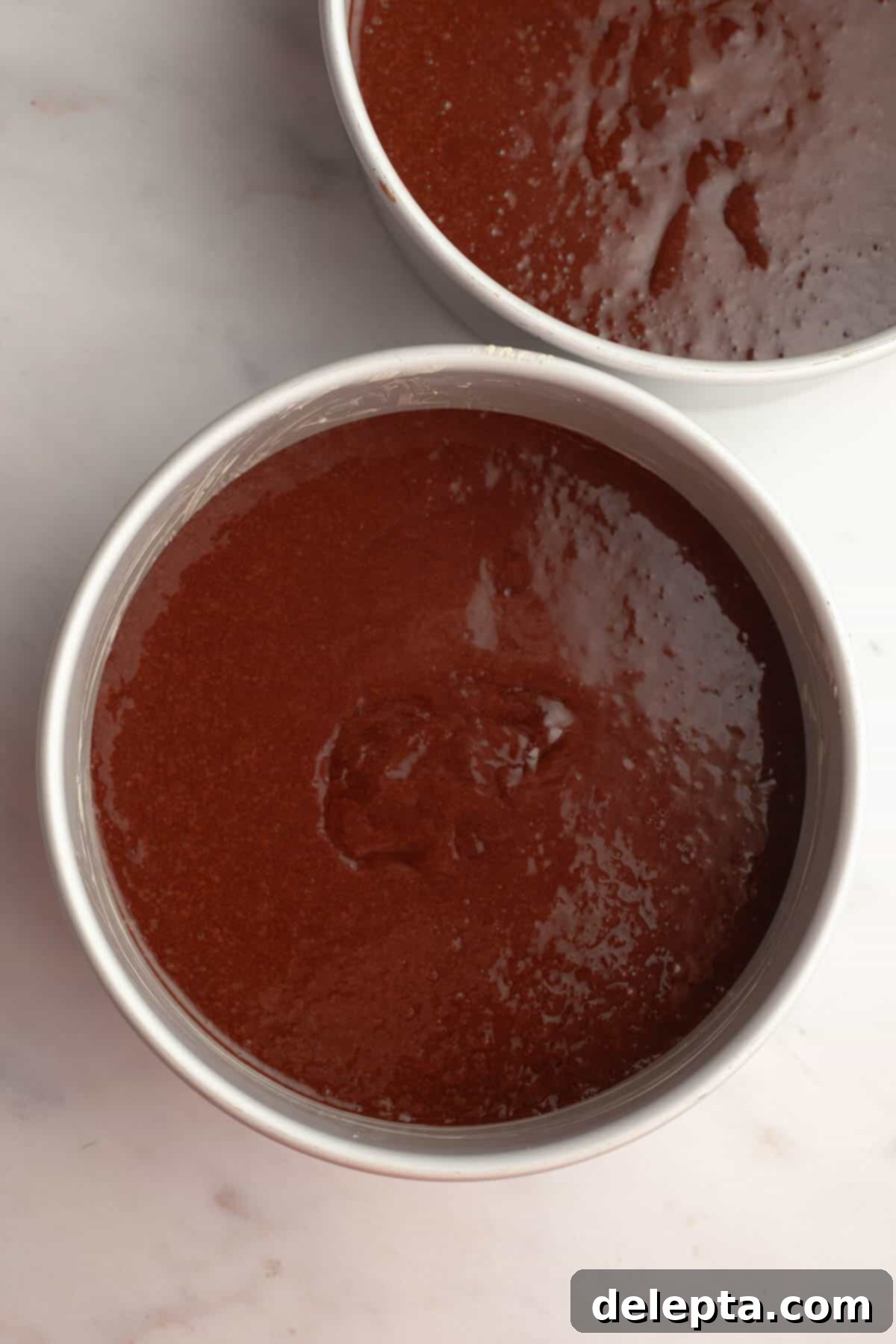 Simple Mocha Delight 7 Two round cake pans filled with unbaked chocolate cake batter, ready for the oven.