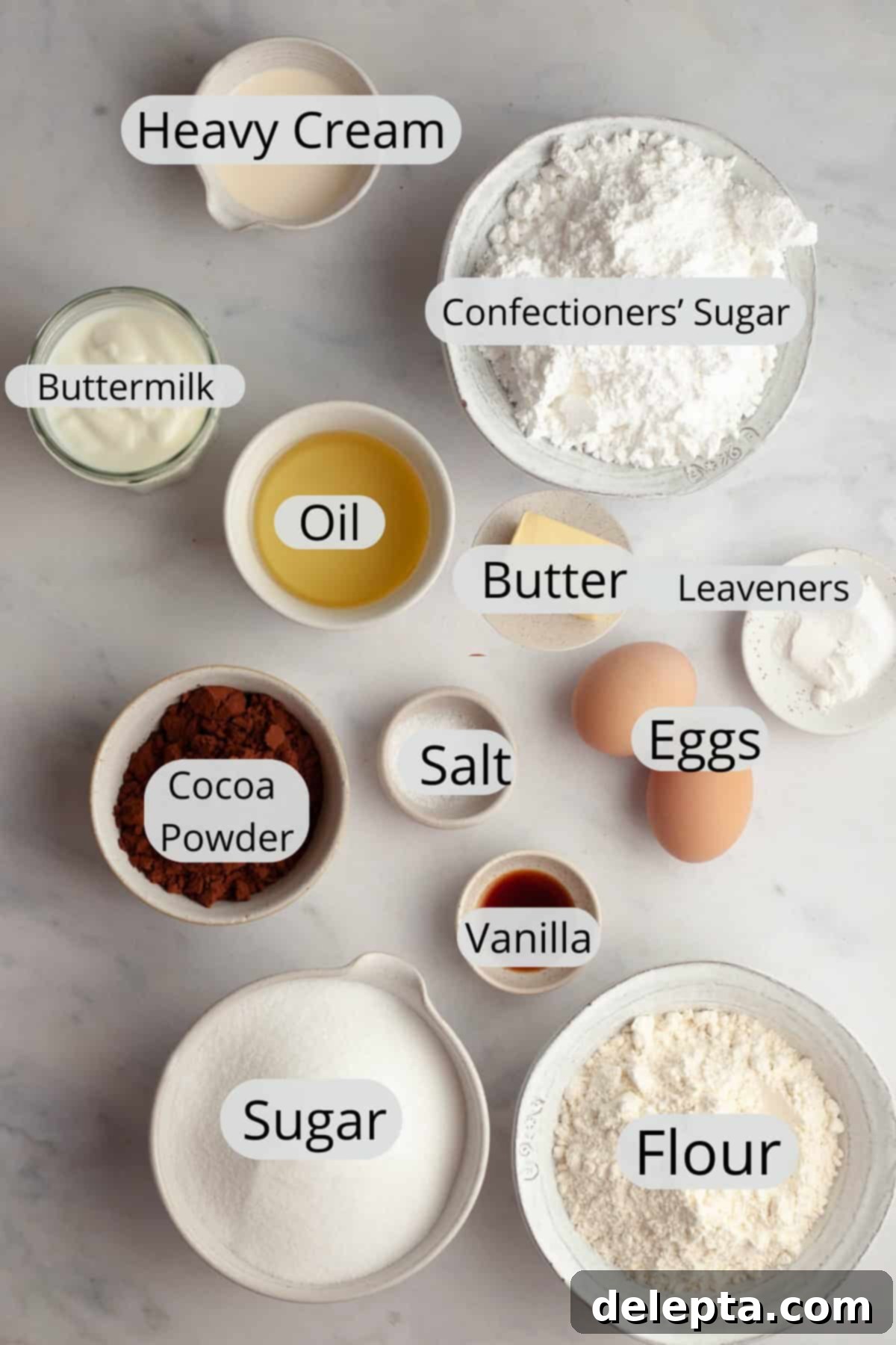 Foolproof Chocolate Cake with Sweet Vanilla Frosting 3 All the ingredients needed to make a chocolate cake and vanilla frosting, weighed out into small bowls, ready for baking.