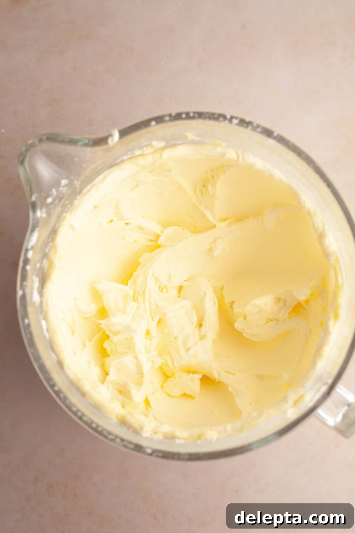 Foolproof Chocolate Cake with Sweet Vanilla Frosting 8 A large mixing bowl with creamed butter and sugar, forming the base of the vanilla frosting.