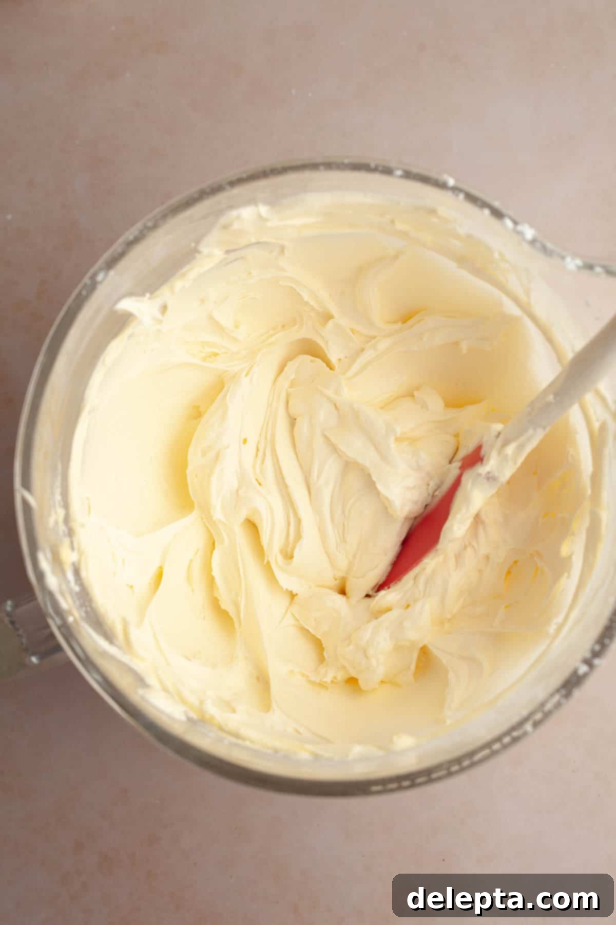 Foolproof Chocolate Cake with Sweet Vanilla Frosting 9 Vanilla frosting in a large glass bowl, smooth and creamy, ready for the cake.