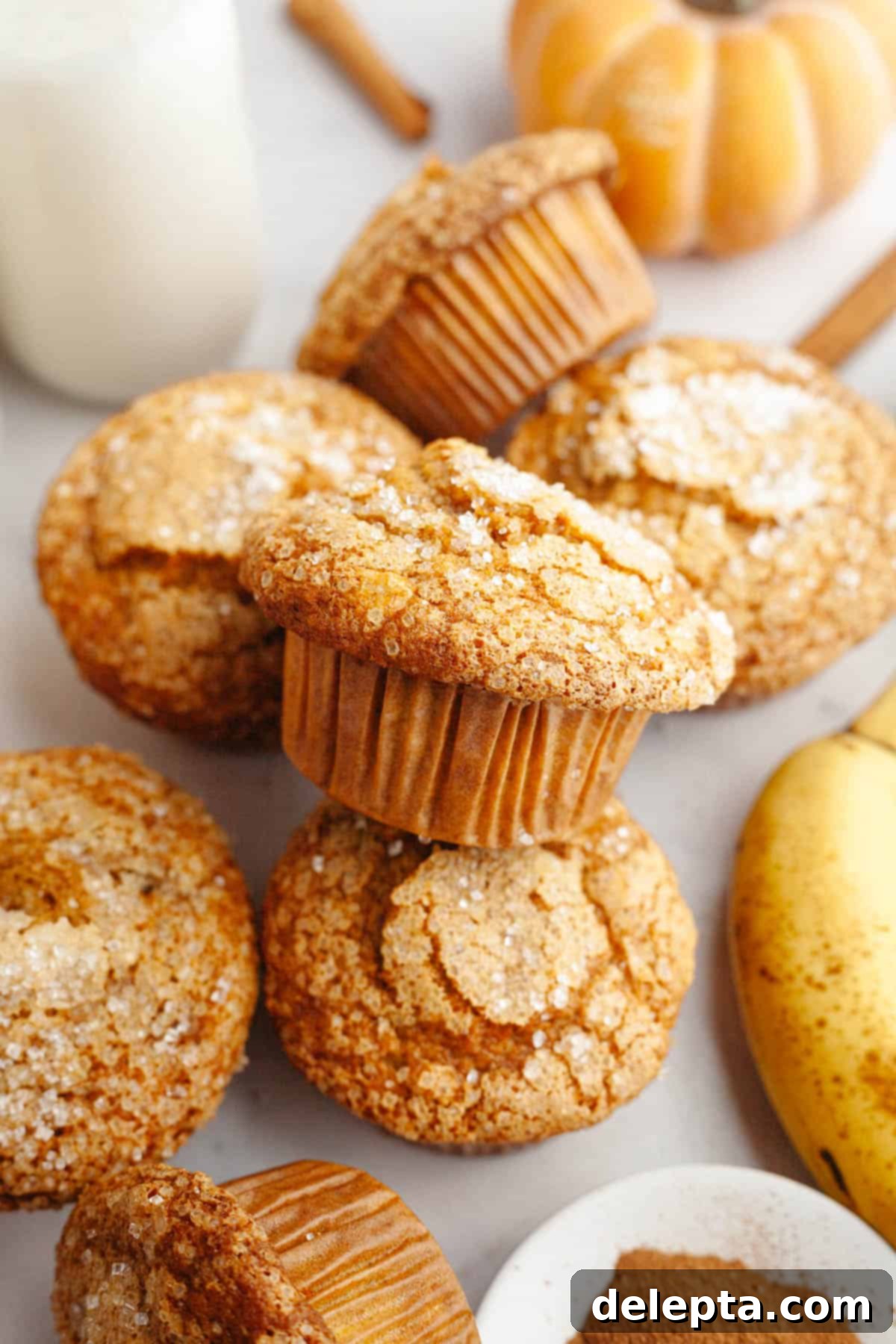 Effortlessly Moist Pumpkin Banana Muffins 8 A bunch of pumpkin banana muffins on a counter top.