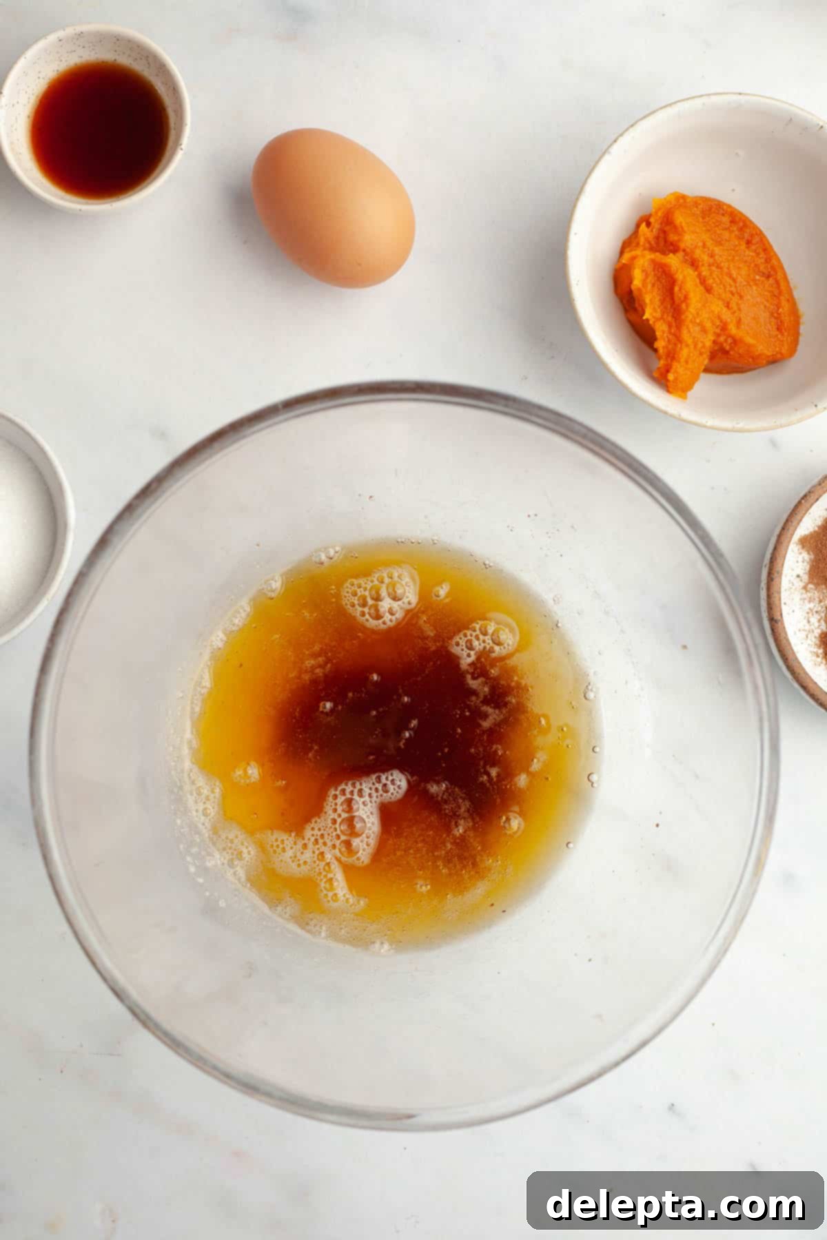 Ultimate Soft and Chewy Pumpkin Cookies 4 Brown butter in a glass bowl, showcasing its rich, golden-brown color.