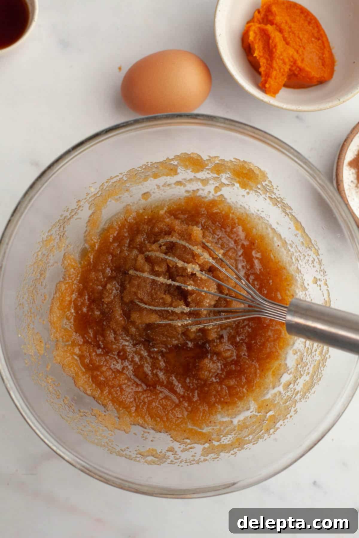 Ultimate Soft and Chewy Pumpkin Cookies 5 Whisked melted brown butter and sugar together in a bowl, creating a smooth mixture.