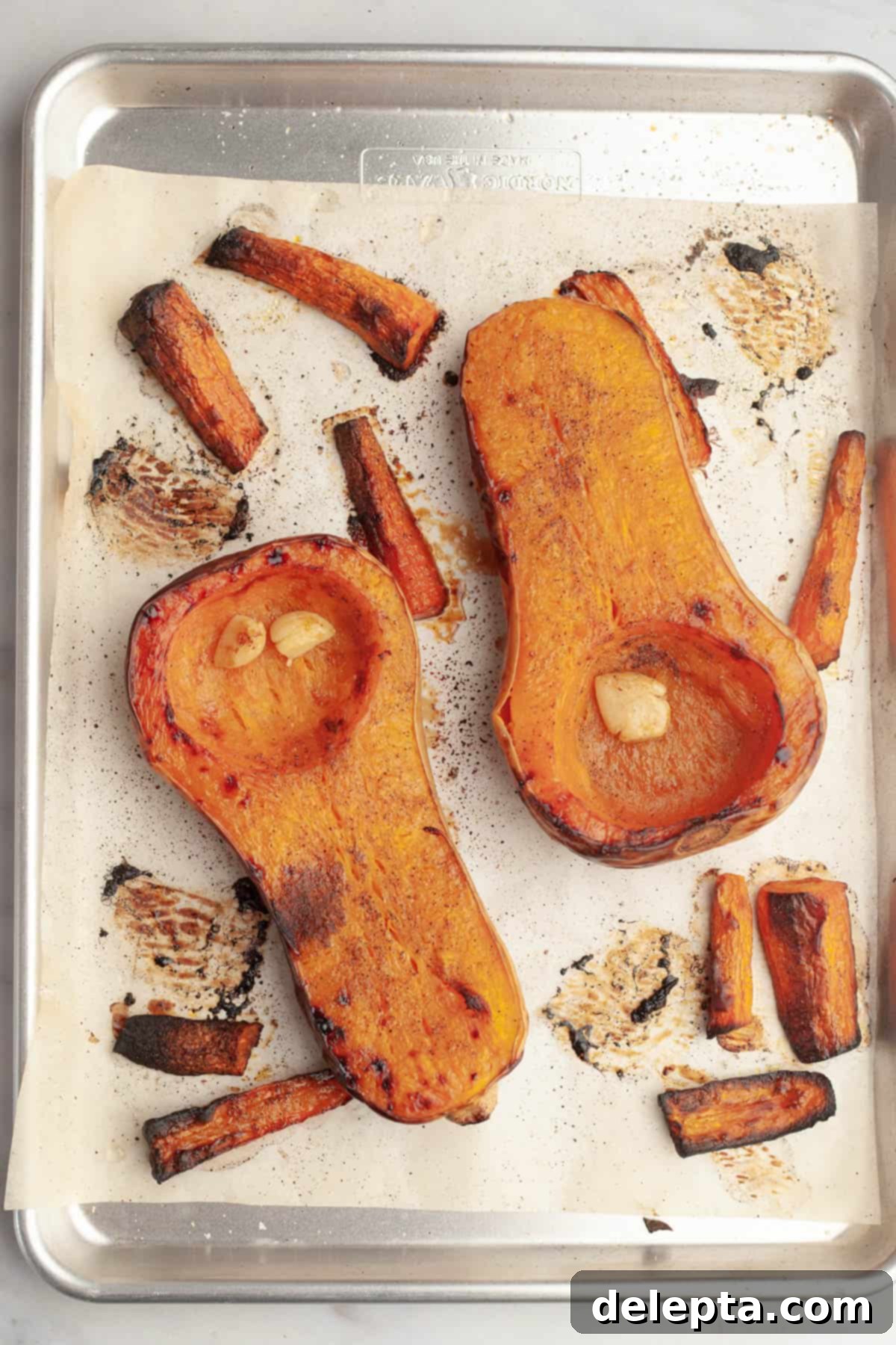 Warm Roasted Butternut & Carrot Ginger Soup 7 Roasted butternut squash and carrots on a sheet tray.
