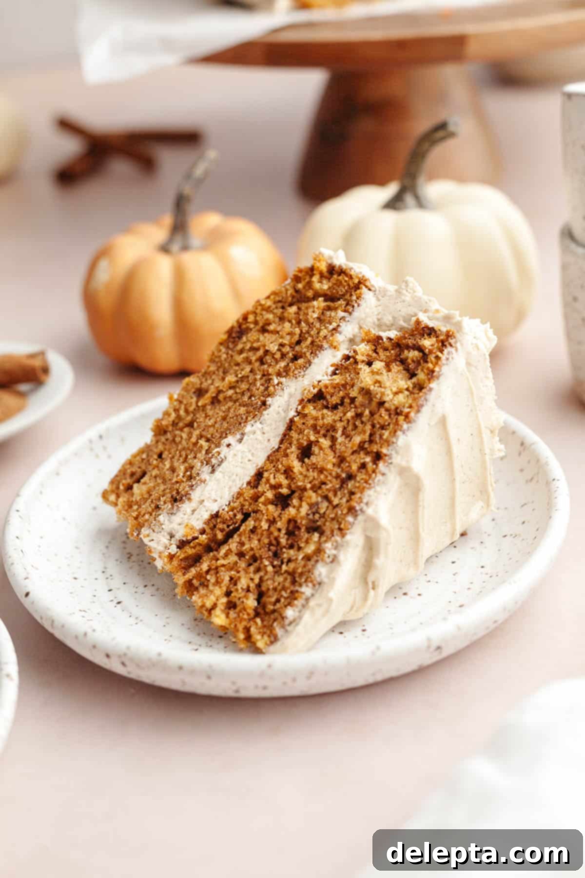 Pumpkin Spiced Latte Cake Bake 11 Another perspective of a slice of pumpkin spice latte cake with coffee frosting on a white plate, highlighting its delicious layers.