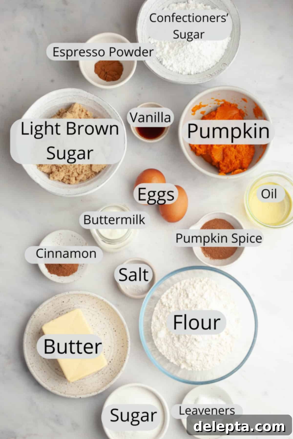 Pumpkin Spiced Latte Cake Bake 3 A collection of all the necessary ingredients for making a pumpkin spice latte cake, meticulously measured out into individual small bowls, showcasing the preparation stage.