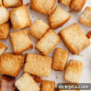Whip Up Perfect Brioche Croutons at Home 9 A baking sheet laden with freshly baked, golden, and crispy brioche croutons, cooling after being removed from the oven.