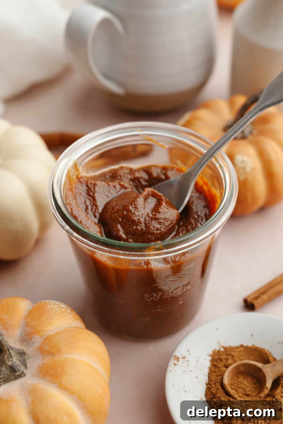 Easy Homemade Pumpkin Spice Syrup 2 A charming glass jar filled with luscious homemade pumpkin spice sauce, ready to be enjoyed.