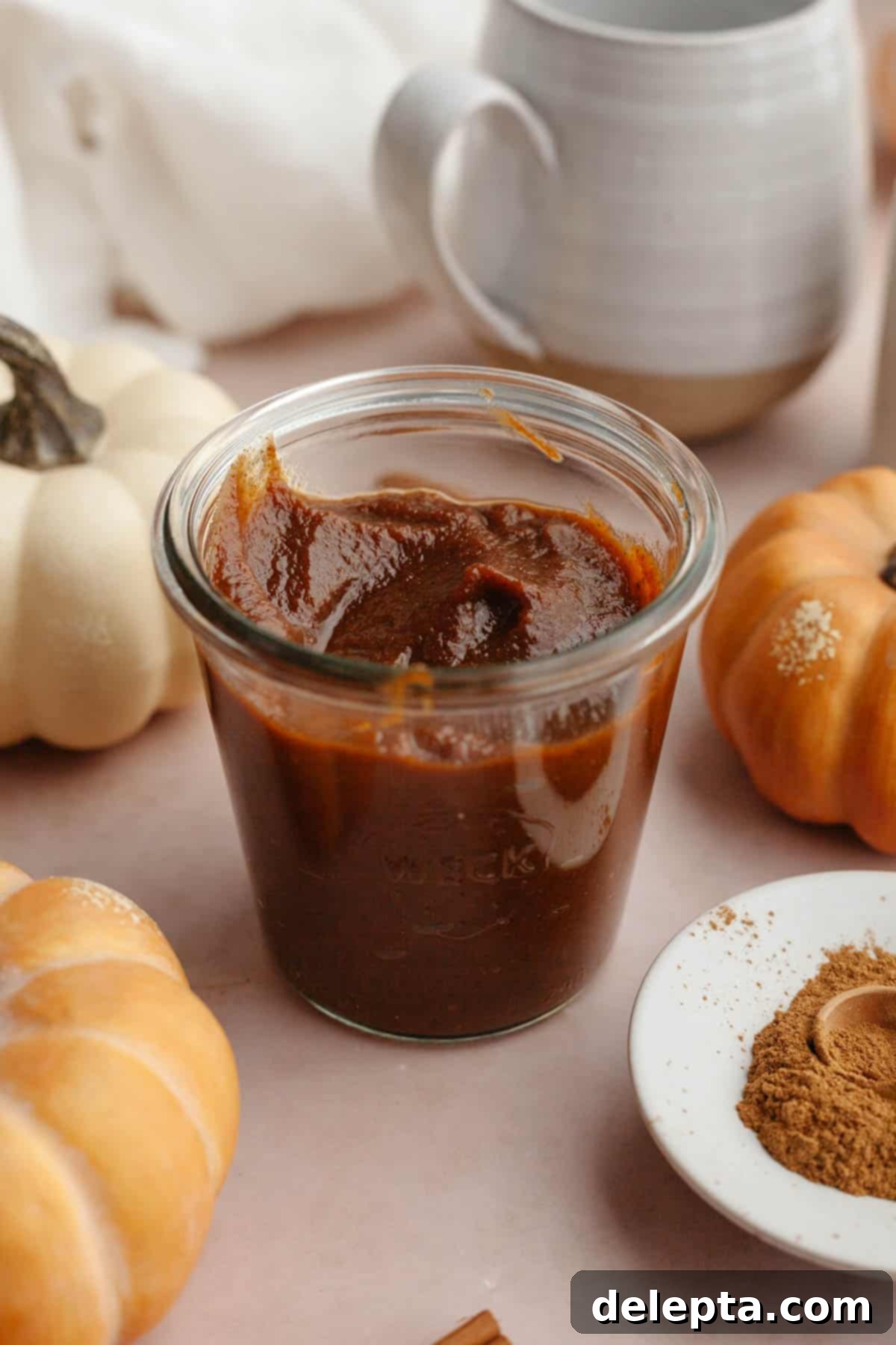 Easy Homemade Pumpkin Spice Syrup 7 Rich pumpkin sauce cooling in a clear glass jar, ready for storage.