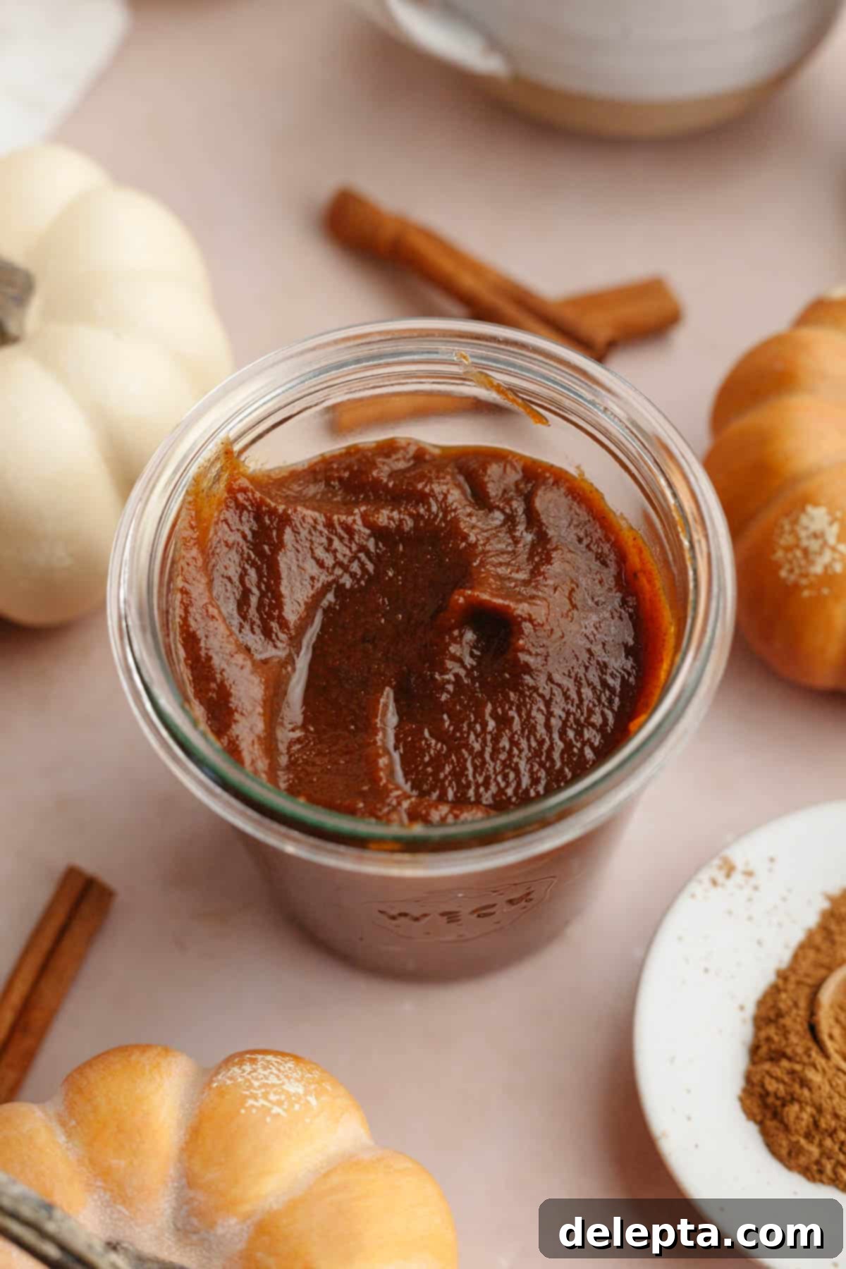 Easy Homemade Pumpkin Spice Syrup 8 A beautifully textured pumpkin spice sauce in a glass jar, highlighting its rich color.