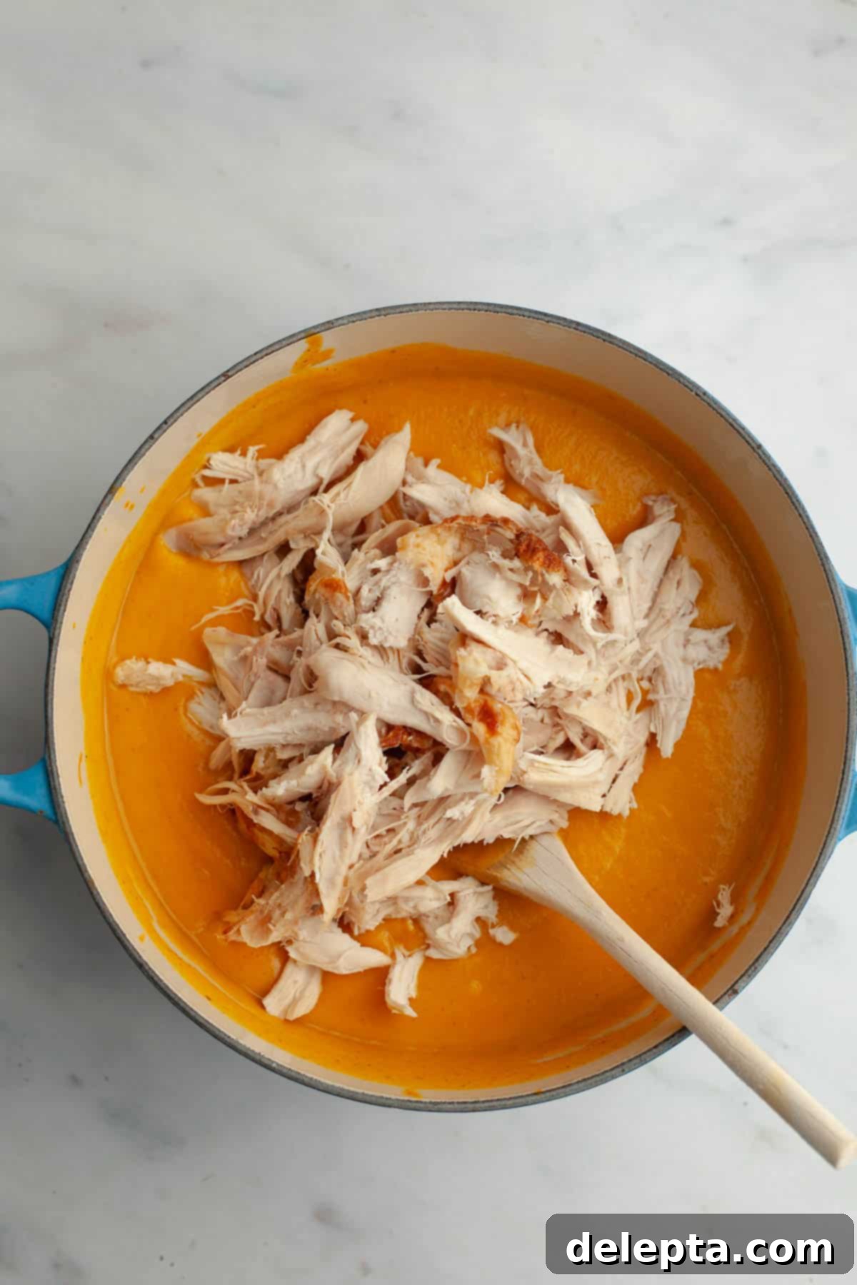 Autumn Gold Roasted Butternut Chicken Soup 9 A large stock pot filled with creamy butternut squash soup and generous amounts of shredded rotisserie chicken, simmering gently.