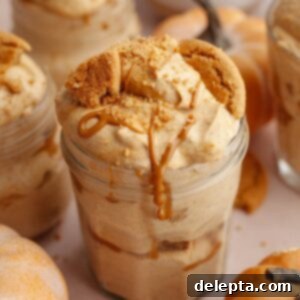 Effortless No Bake Pumpkin Delights 12 Pumpkin pie cups in mason jars, topped with crushed gingersnap cookies and drizzled cookie butter.