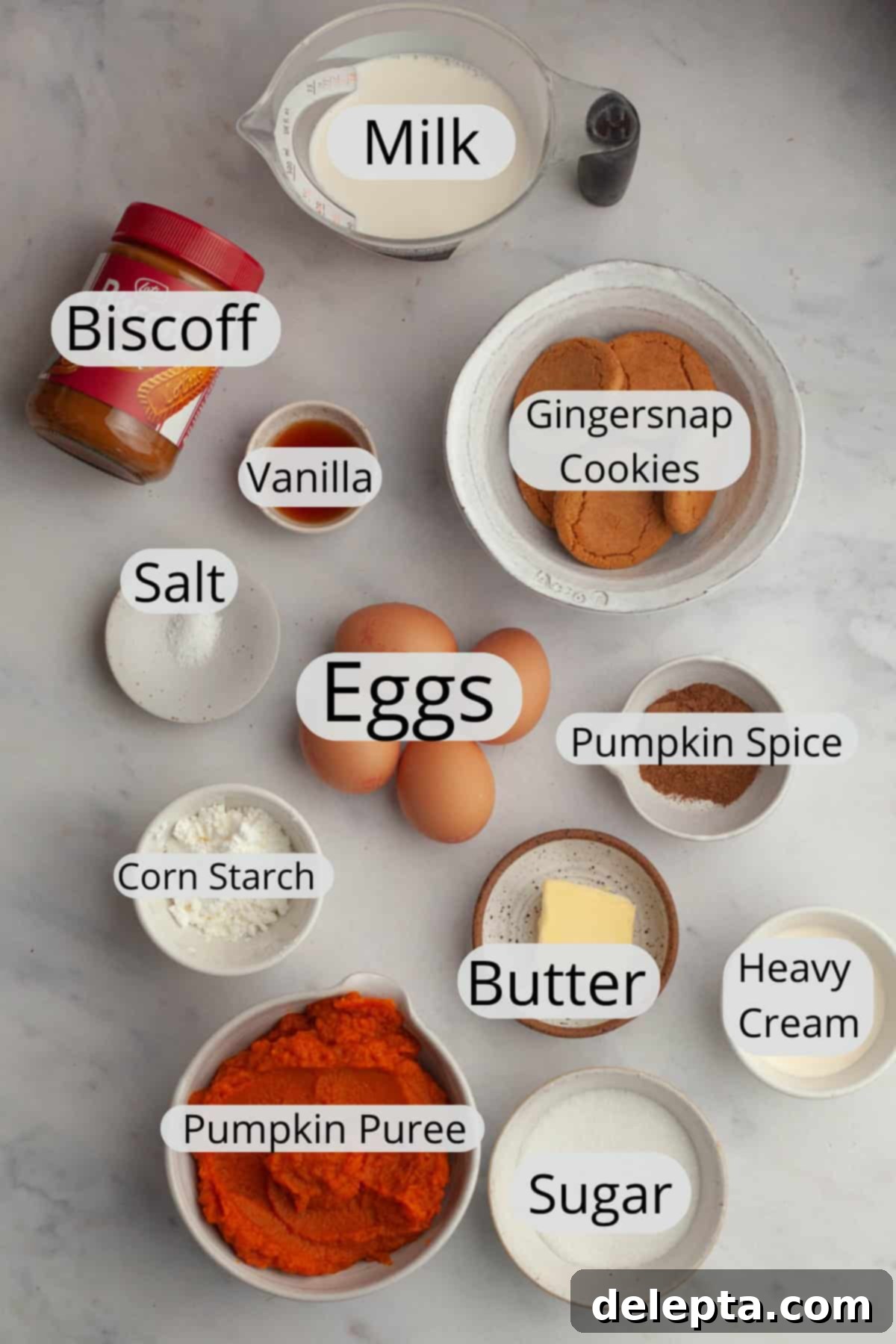 Effortless No Bake Pumpkin Delights 3 All the pre-measured ingredients for homemade pumpkin pudding cups, arranged in small bowls on a wooden surface.