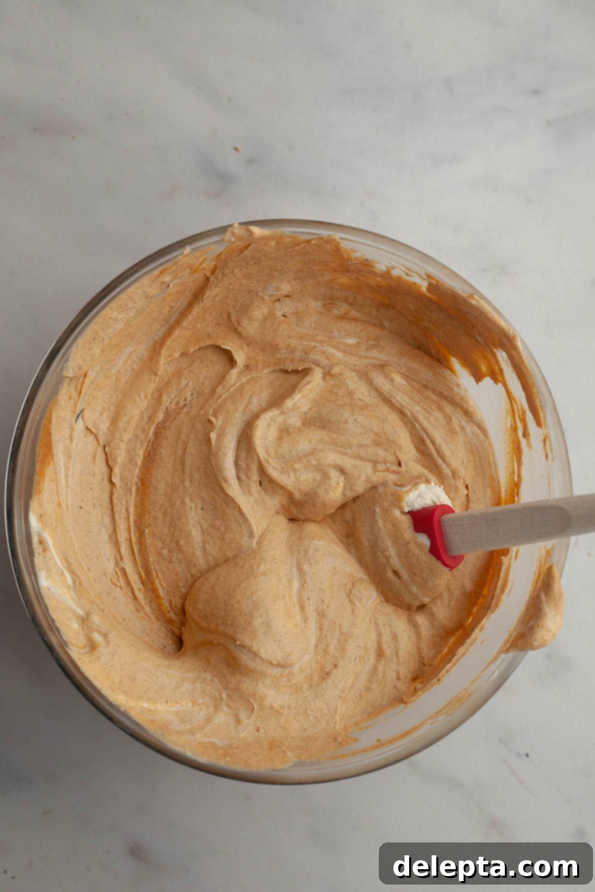 Effortless No Bake Pumpkin Delights 9 A bowl of fully chilled and set pumpkin pudding, ready to be folded with whipped cream.