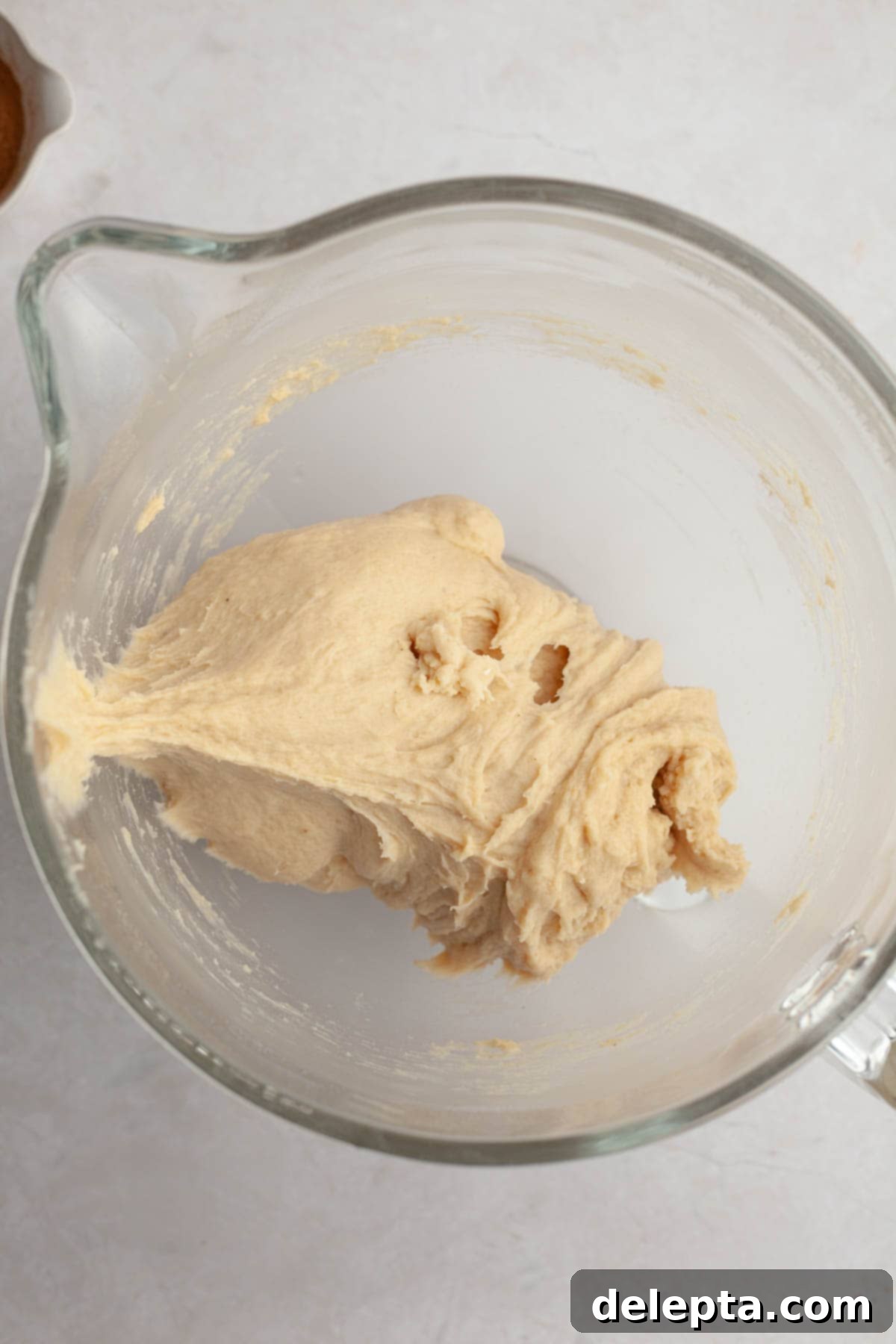 Rich Brown Butter Cinnamon Rolls with Velvety Brown Butter Frosting 6 Brioche cinnamon roll dough in a glass bowl.