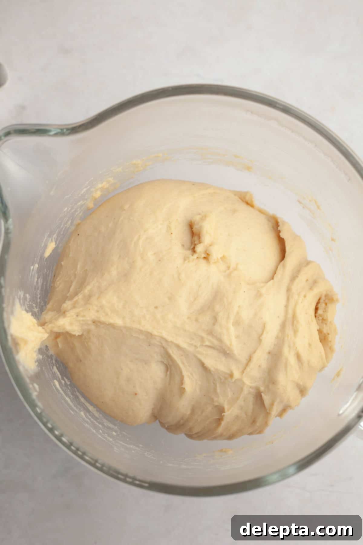 Rich Brown Butter Cinnamon Rolls with Velvety Brown Butter Frosting 7 Brioche cinnamon roll dough in a glass bowl.