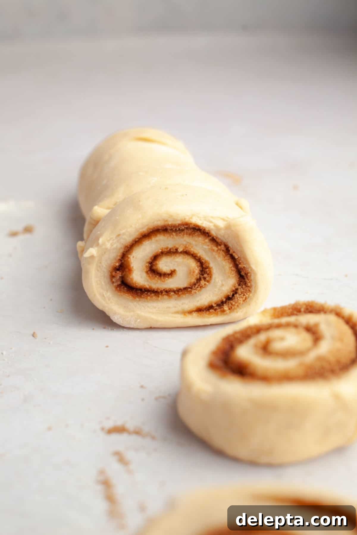 Rich Brown Butter Cinnamon Rolls with Velvety Brown Butter Frosting 10 A brown butter cinnamon roll log being sliced.