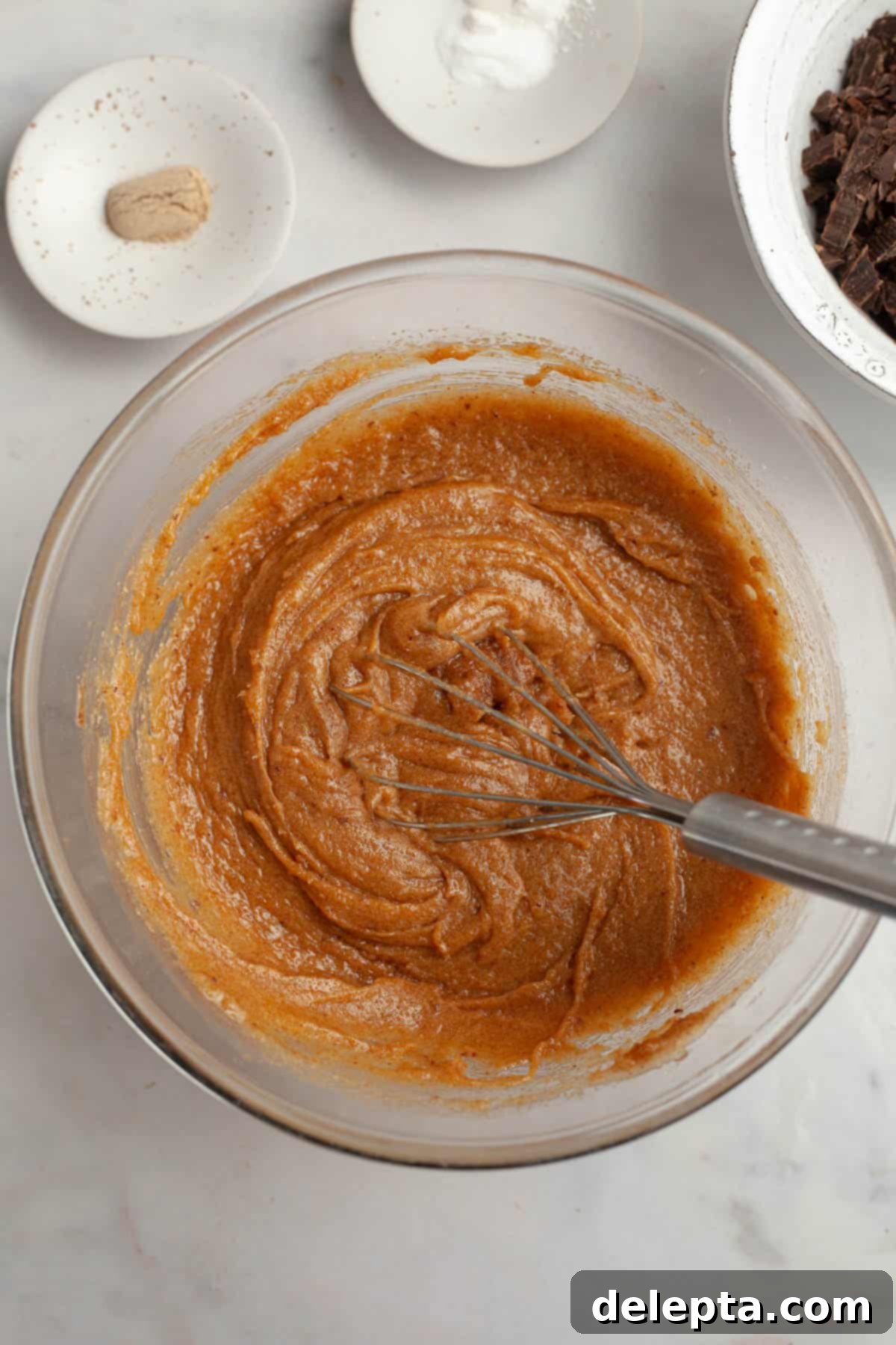 Decadent Espresso Infused Brown Butter Chocolate Cookies 6 Cookie dough in a glass bowl with a whisk.