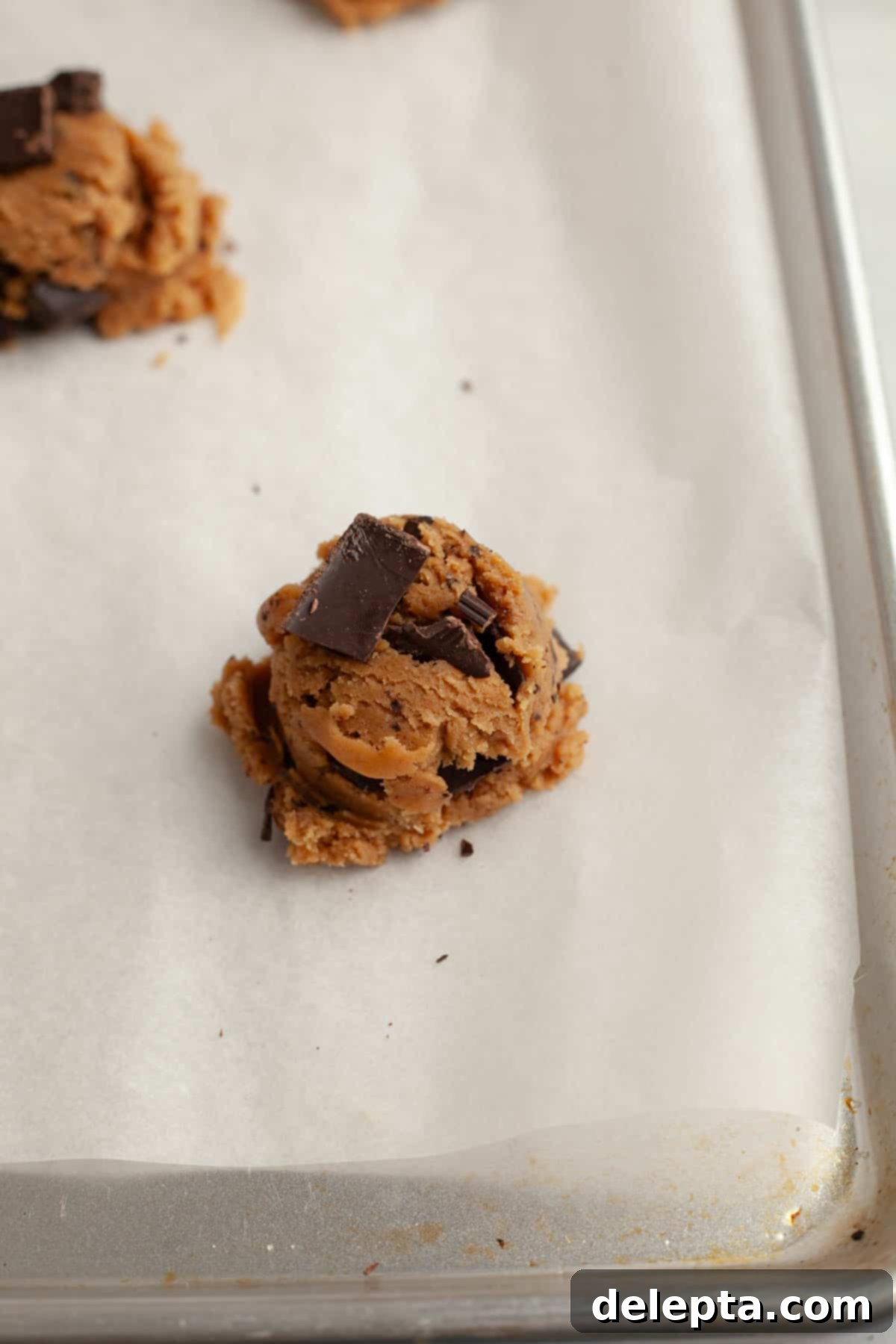 Decadent Espresso Infused Brown Butter Chocolate Cookies 9 Brown butter chocolate chunk espresso cookie dough balls on parchment paper.