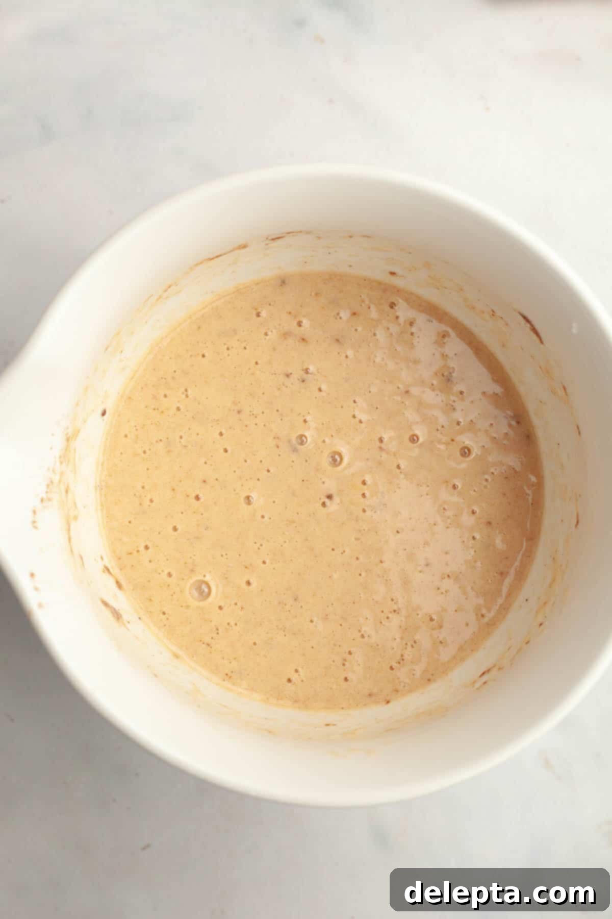 Effortless Buttermilk Brioche French Toast 4 French toast buttermilk mixture in a white bowl, perfectly blended and ready for dipping.