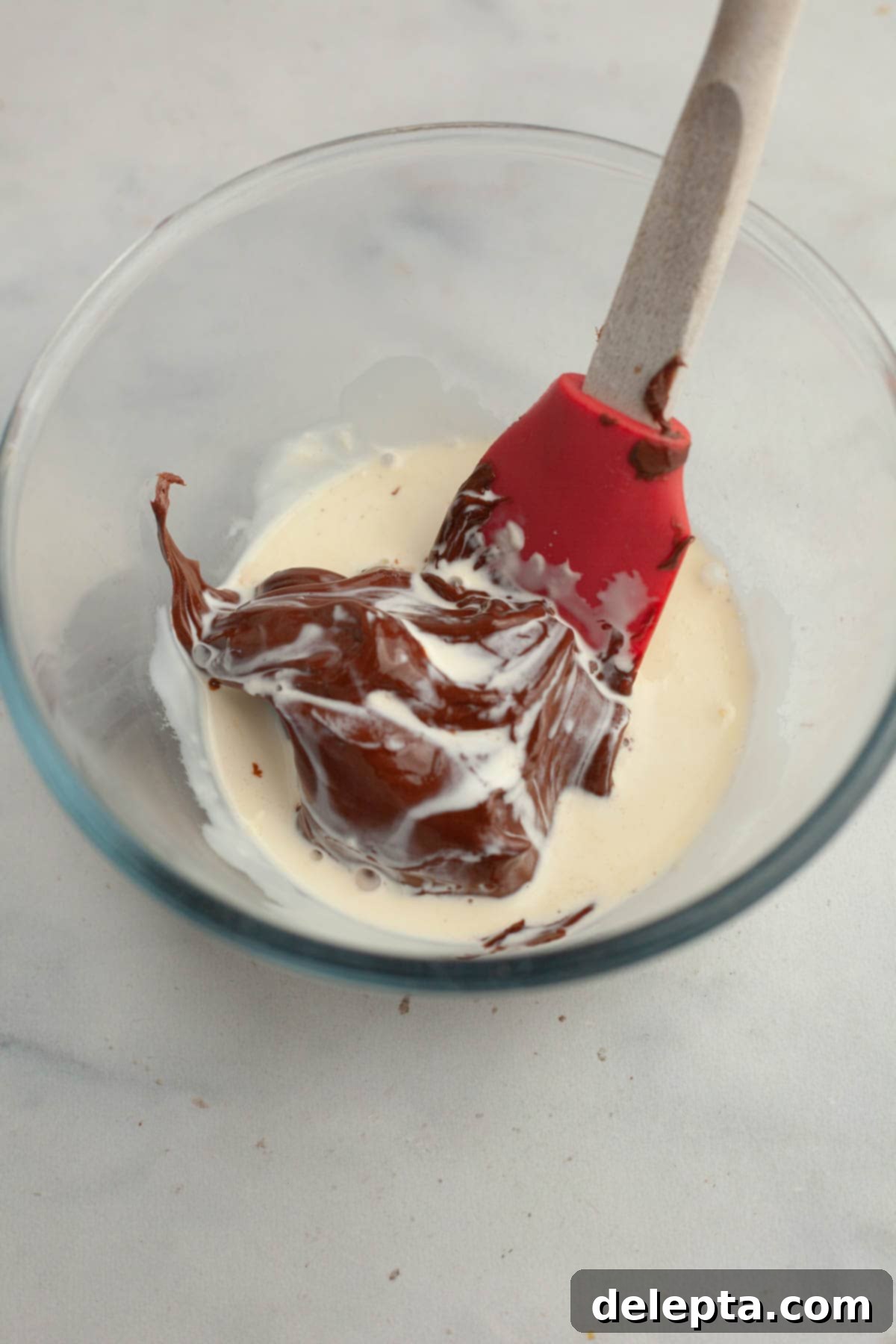 Double Nutella Bliss: Easy Thumbprint Cookies with Ganache 10 A small glass bowl with Nutella and heavy cream, prior to being mixed into ganache.