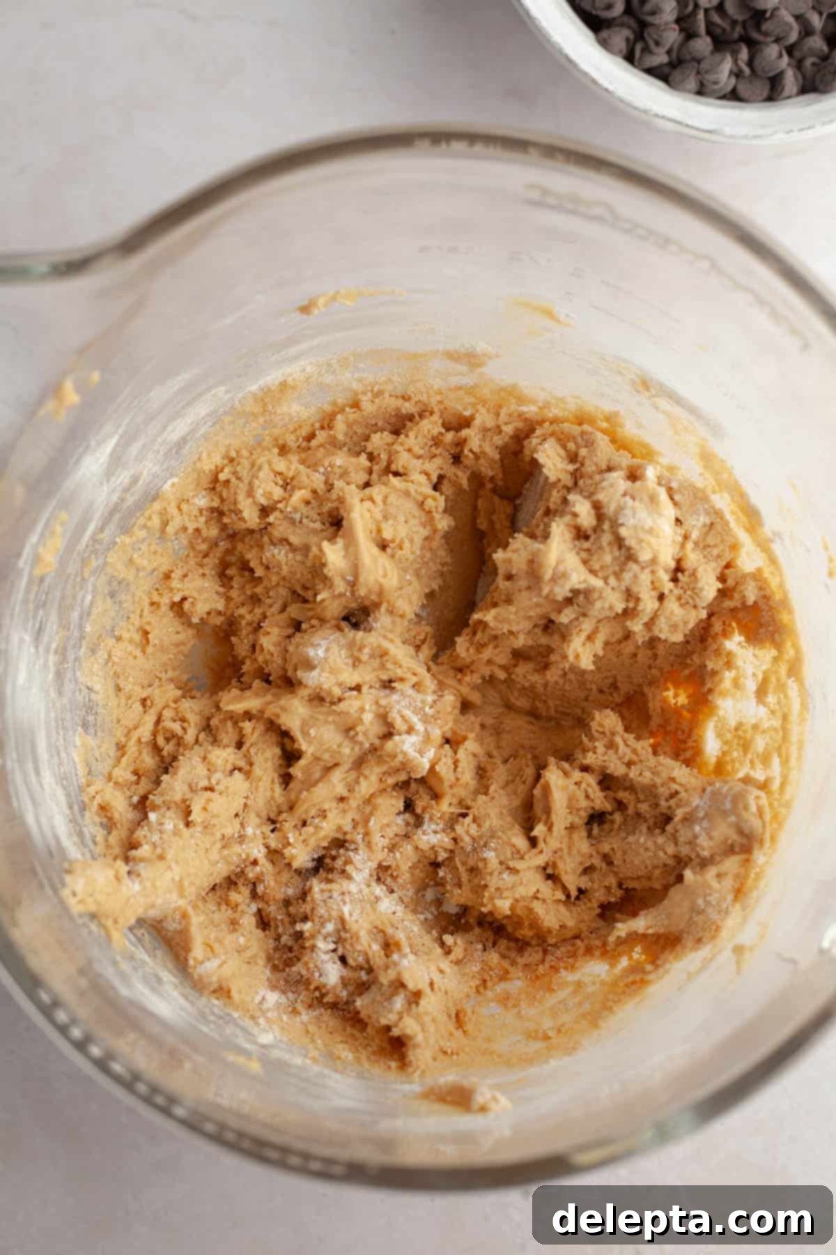 Decadent Peanut Butter Nutella Stuffed Chocolate Chip Cookies 7 Peanut butter cookie dough in a large mixing bowl with dry ingredients just combined.