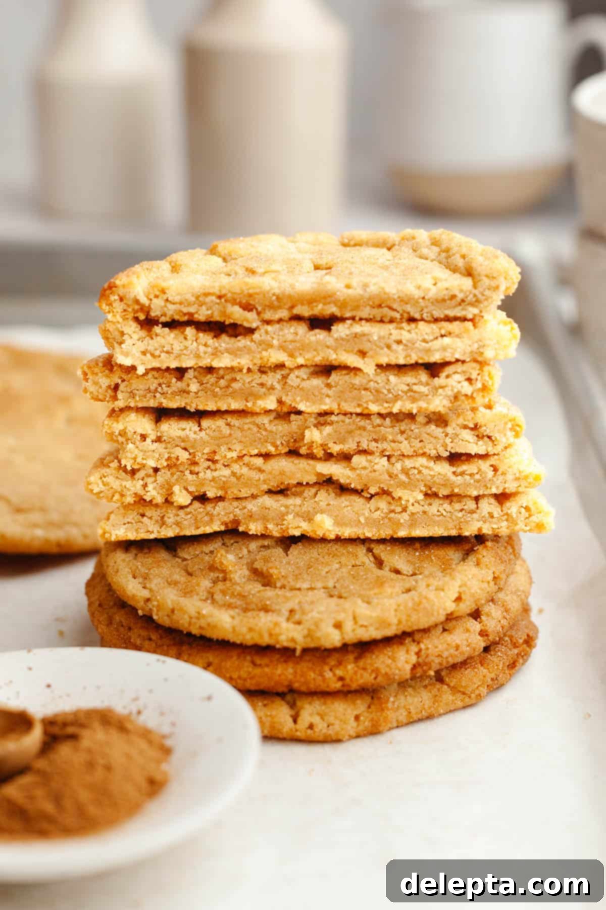 Peanut Butter Snickerdoodle Bliss 11 A neatly stacked pile of peanut butter snickerdoodles, with some cut in half to showcase their delightful texture.