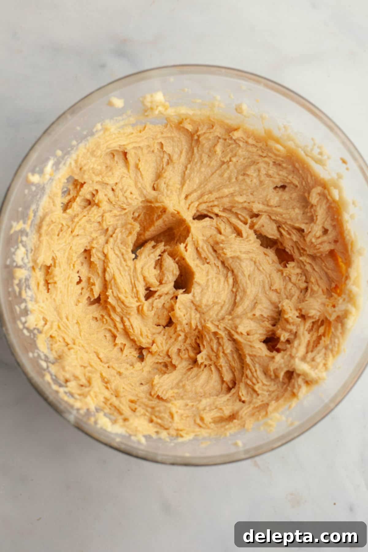 Peanut Butter Snickerdoodle Bliss 6 Smooth peanut butter cookie dough being mixed in a bowl.