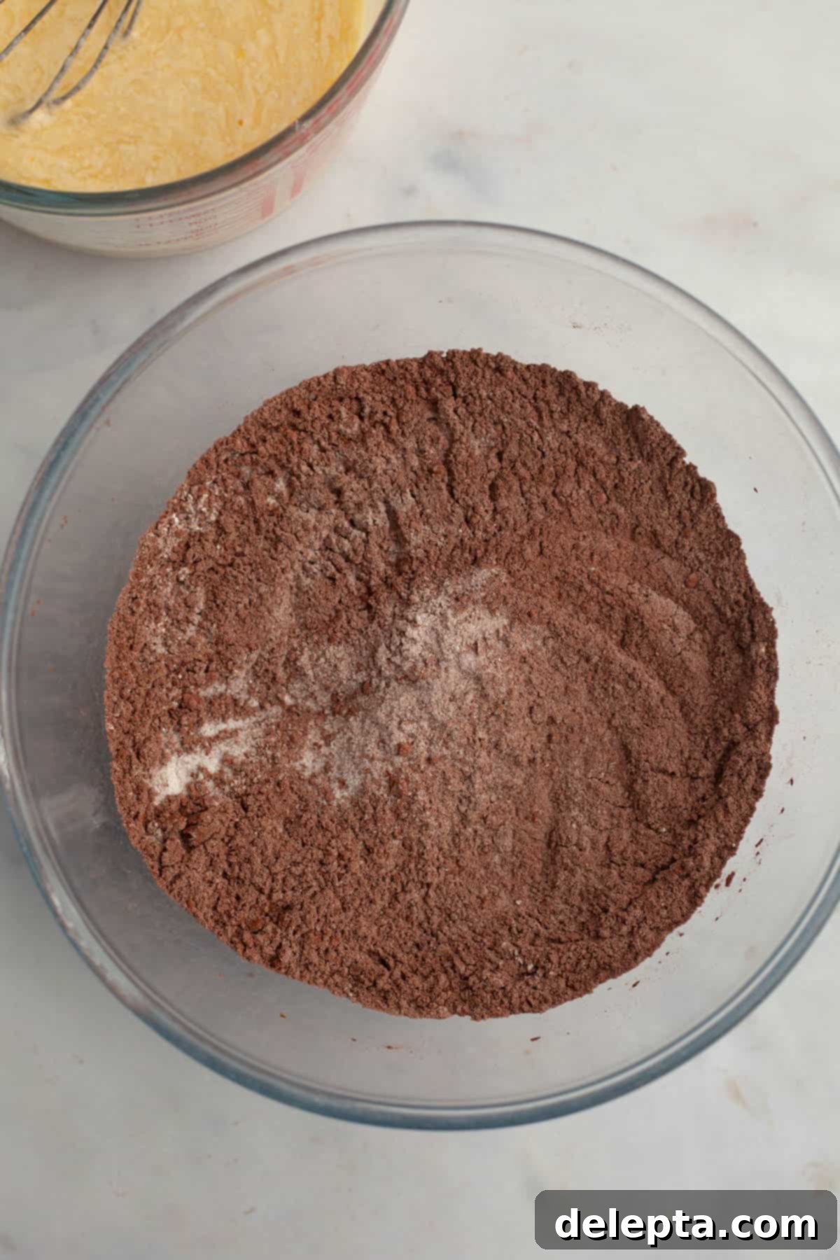 Peppermint Chocolate Dream Cupcakes 4 Flour and cocoa powder in a glass bowl, ready to be whisked for the cupcake batter.
