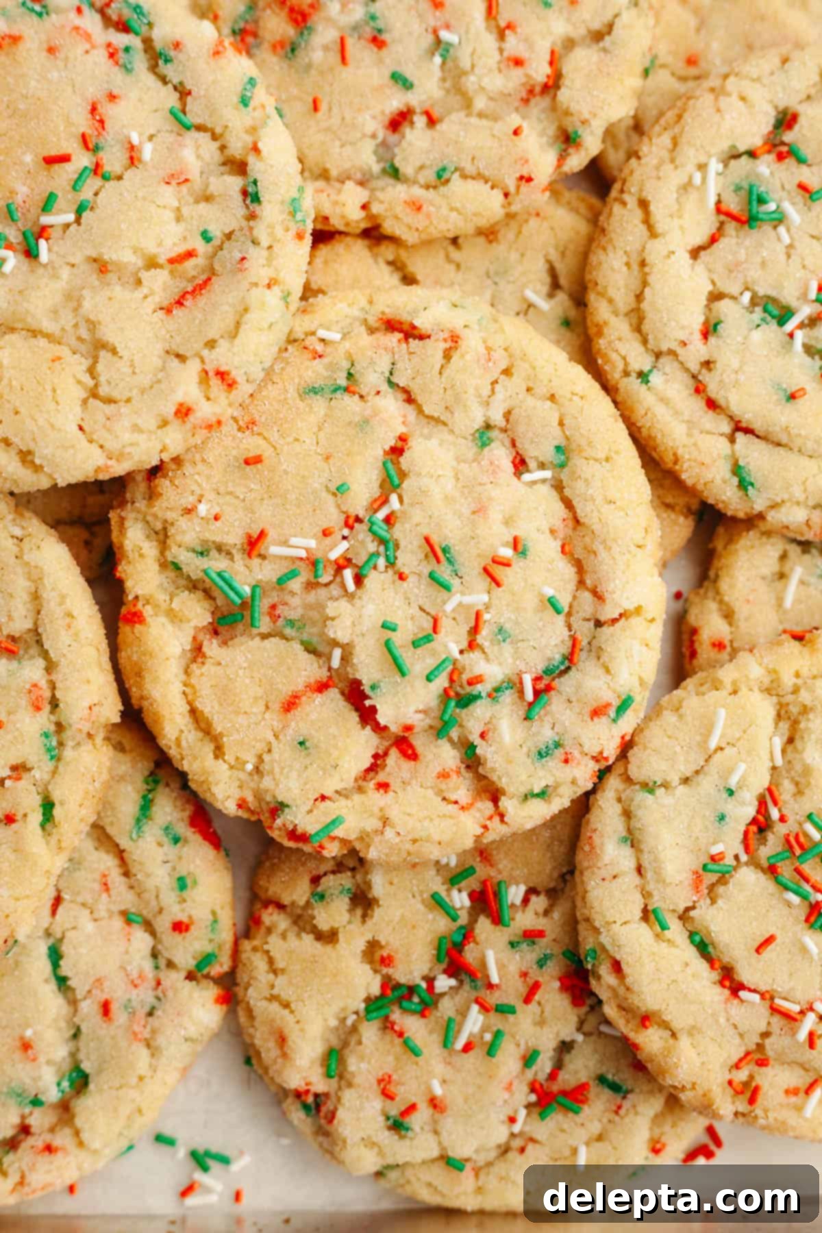 Melt-in-Your-Mouth Brown Butter Christmas Sprinkle Cookies 2 A close up of Christmas sprinkle sugar cookies with red, white, and green sprinkles, showcasing their soft texture and festive appearance.