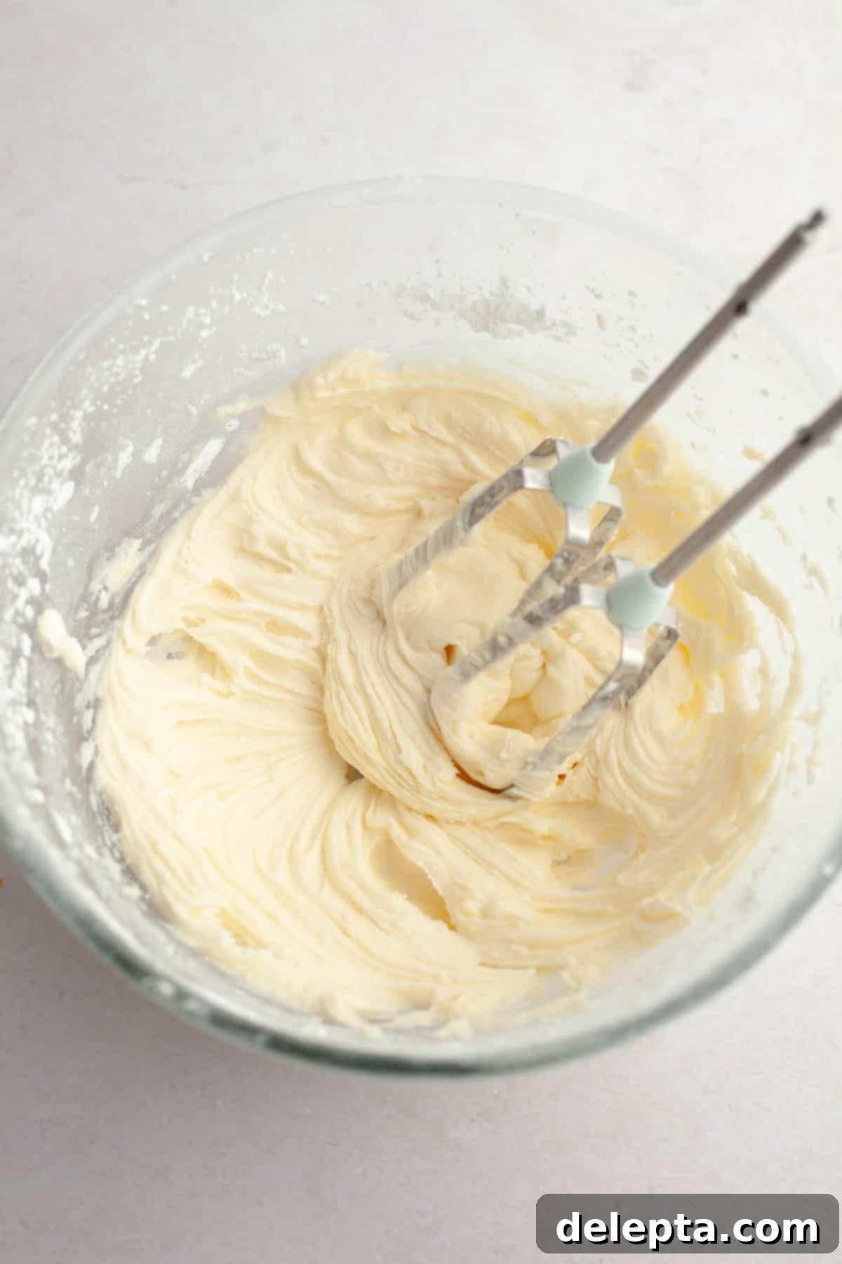 Velvet Gingerbread Cookies with Cream Cheese Frosting 10 Smooth, fluffy cream cheese frosting in a mixing bowl, ready for piping.