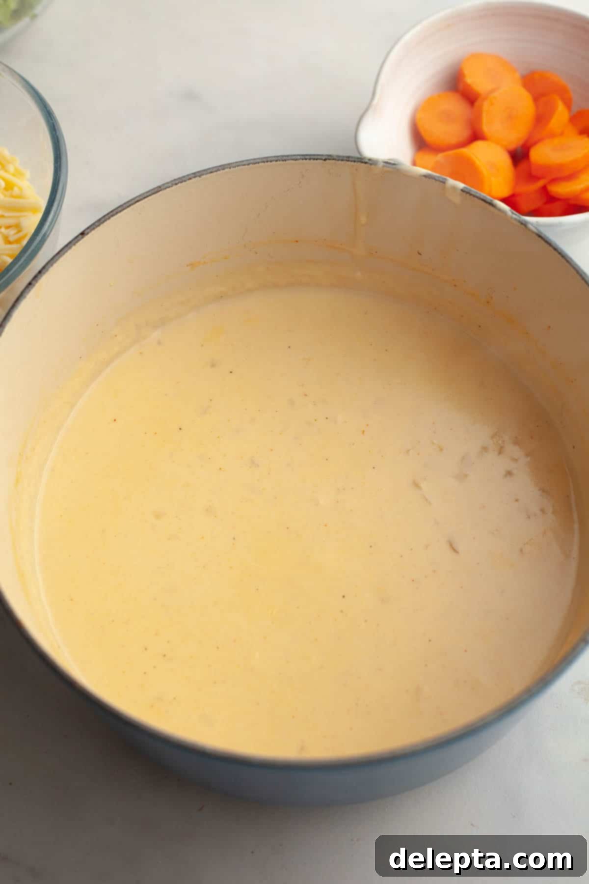 Velvety Chicken and Broccoli Cheddar Soup 6 A large dutch oven filled with the creamy soup base, before the addition of vegetables or chicken.
