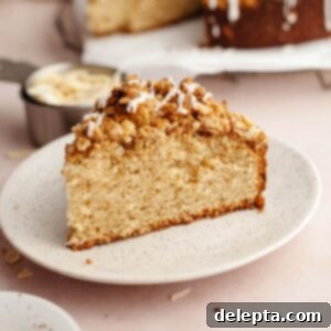 Irresistible Brown Butter Cardamom Almond Cake Recipe 12 A slice of cardamom almond cake with streusel on a small plate.