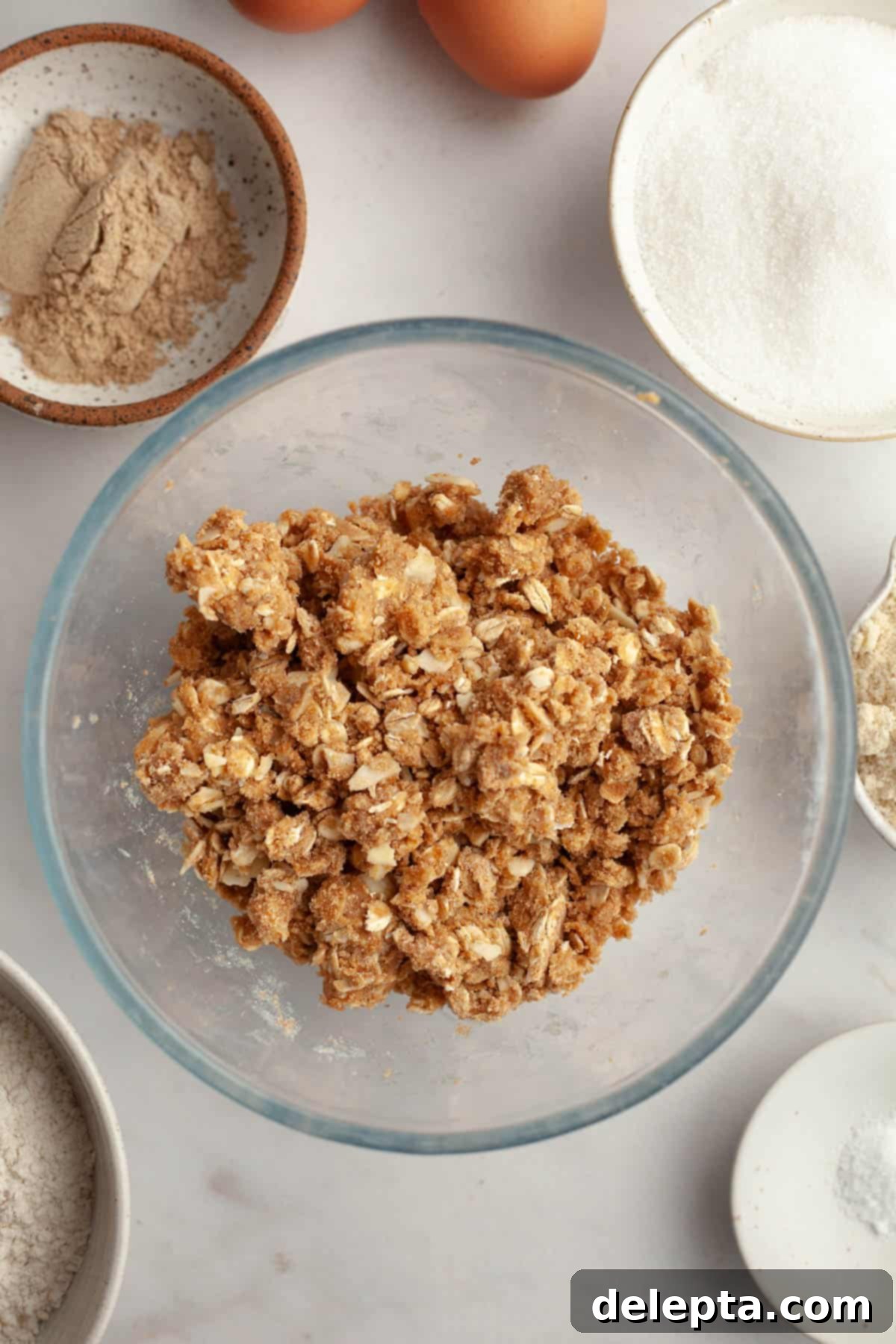 Irresistible Brown Butter Cardamom Almond Cake Recipe 5 An oat streusel in a small glass bowl.