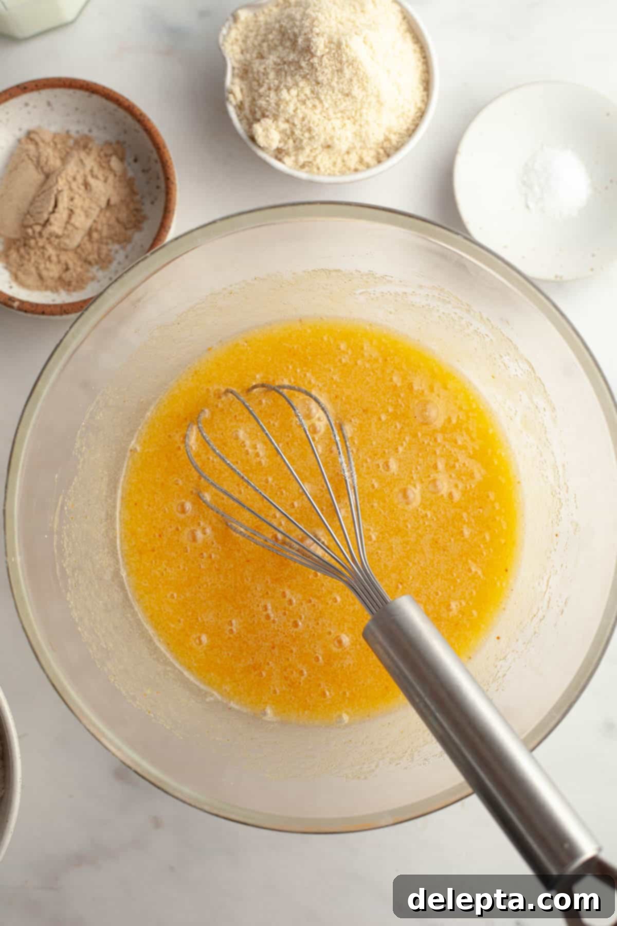 Irresistible Brown Butter Cardamom Almond Cake Recipe 6 A large glass bowl with melted butter, sugar and eggs.