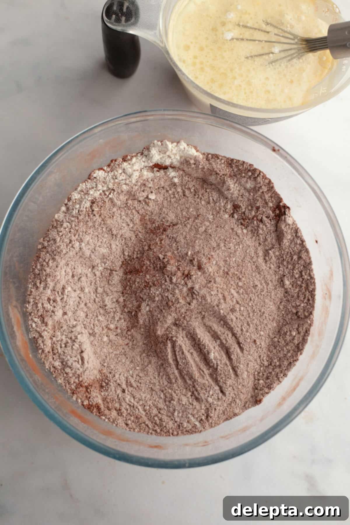Decadent Chocolate Strawberry Dream Cake 4 Cocoa powder and flour in a glass bowl.