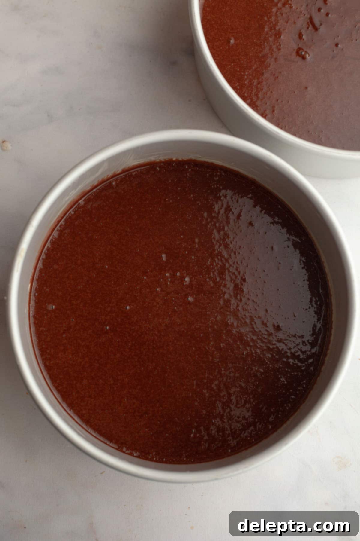 Decadent Chocolate Strawberry Dream Cake 7 Unbaked chocolate cake in round cake pans.