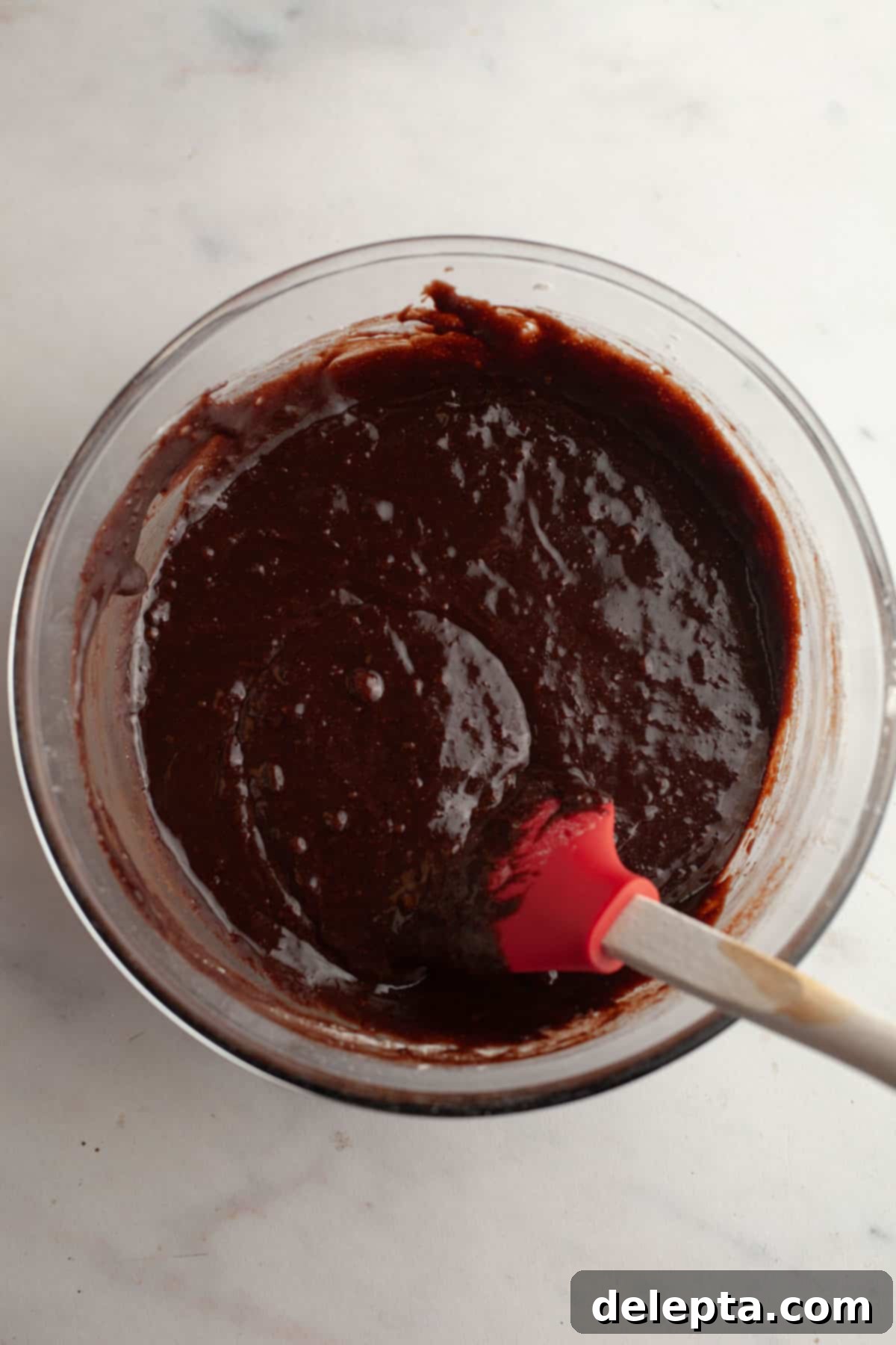 Decadent Peanut Butter Cream Cheese Swirl Brownies 8 A glass bowl with rich brownie batter in it, ready for flour.