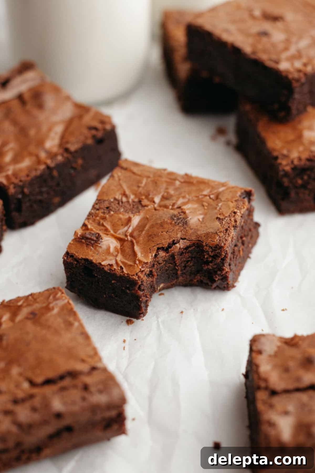 Easy Double Fudge Brownies Better Than Any Bakery 12 A perfectly baked double fudge brownie with a bite taken out of it, revealing its dense, fudgy interior.