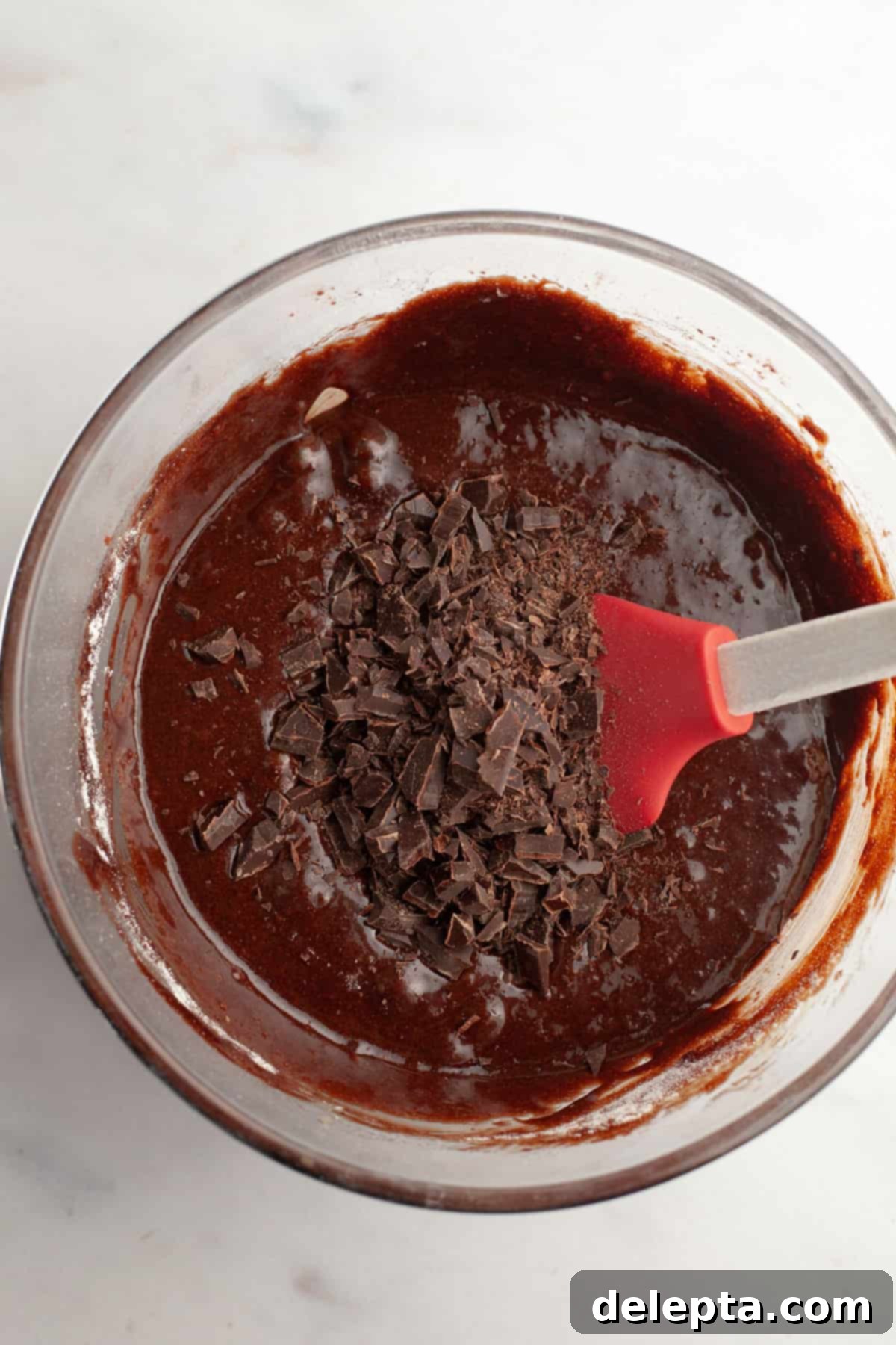 Easy Double Fudge Brownies Better Than Any Bakery 9 Brownie batter with finely chopped chocolate folded in, inside a glass bowl.