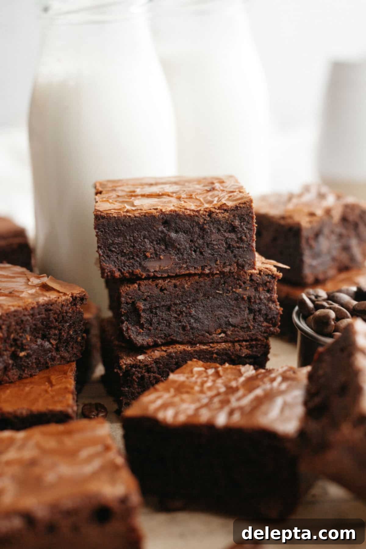 Easy One-Bowl Fudgy Espresso Brownies 11 A stack of three fudgy espresso brownies on parchment paper.