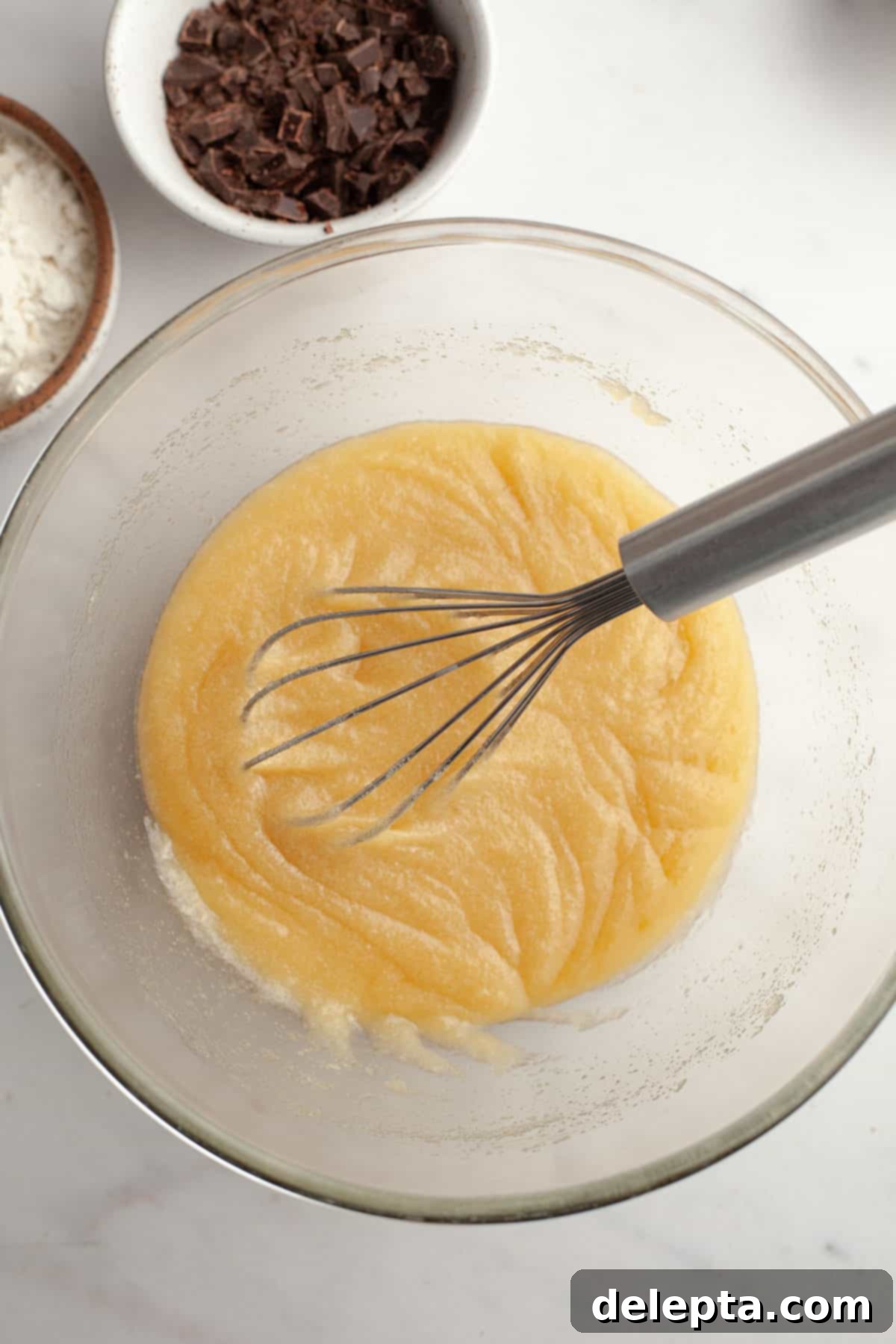 Easy One-Bowl Fudgy Espresso Brownies 4 A glass bowl with sugar and melted butter.