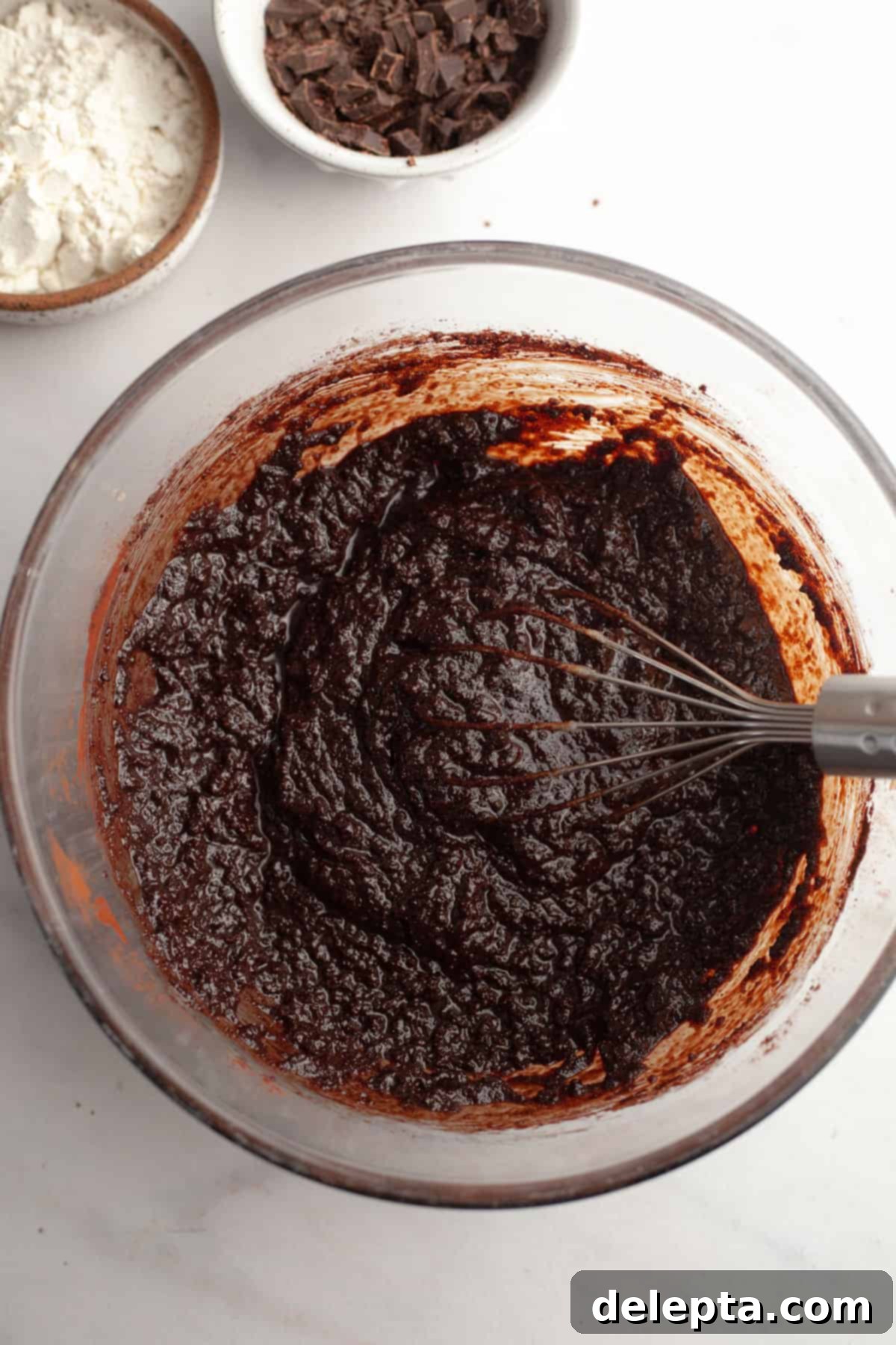 Easy One-Bowl Fudgy Espresso Brownies 5 A glass bowl with brownie batter in it and a whisk.