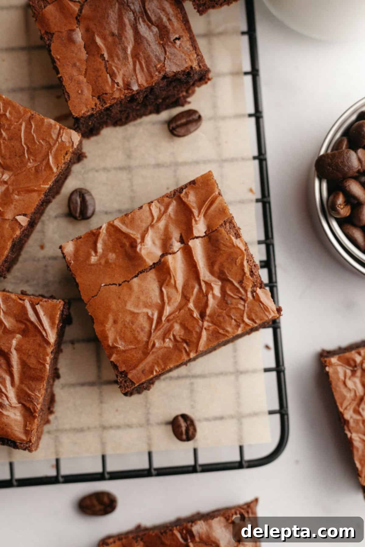 Easy One-Bowl Fudgy Espresso Brownies 10 An overhead shot of brownies sliced up on parchment paper.