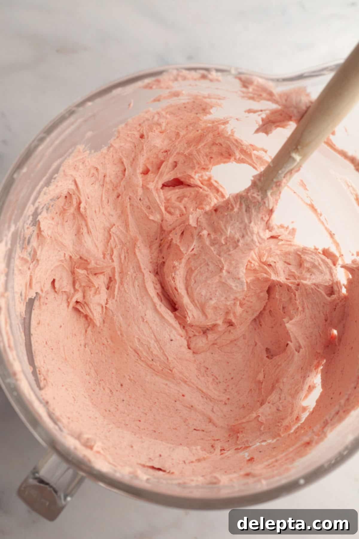 Strawberry Funfetti Fantasy 11 Vibrant pink strawberry buttercream in a large bowl, ready for frosting.