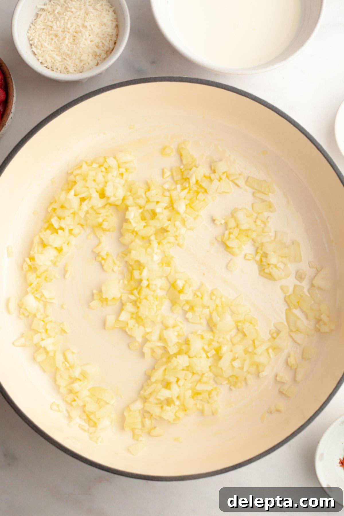 Easy Baked Pasta with Virgin Vodka Sauce 5 Finely chopped onions sautéing in olive oil in a large saucepan.