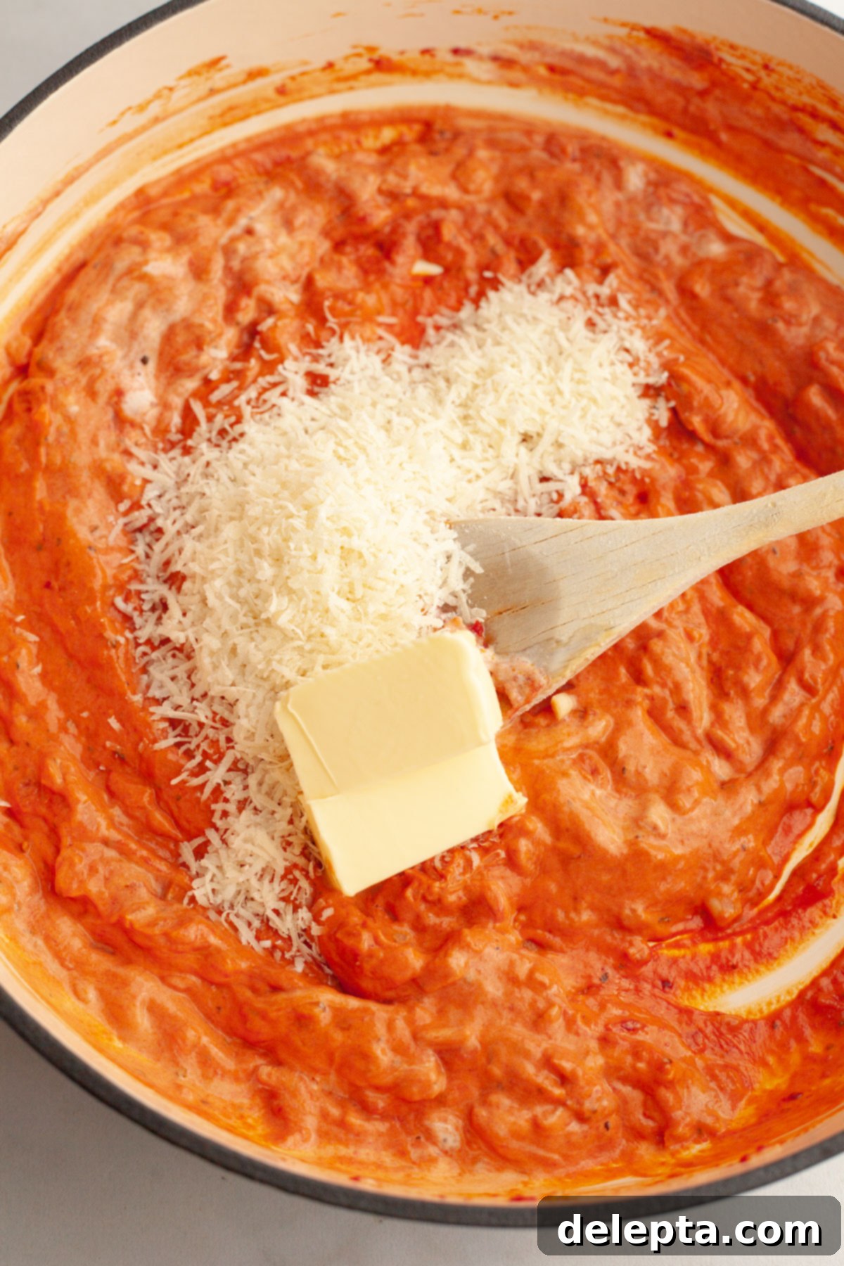 Easy Baked Pasta with Virgin Vodka Sauce 7 Creamy vodka sauce simmering in a large pan with melted butter and grated parmesan.