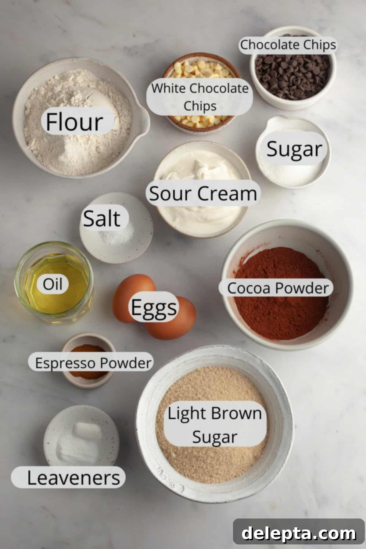 Triple Chocolate Muffins One Bowl Wonder 3 All the pre-measured ingredients for triple chocolate muffins laid out in small bowls, ready for baking.