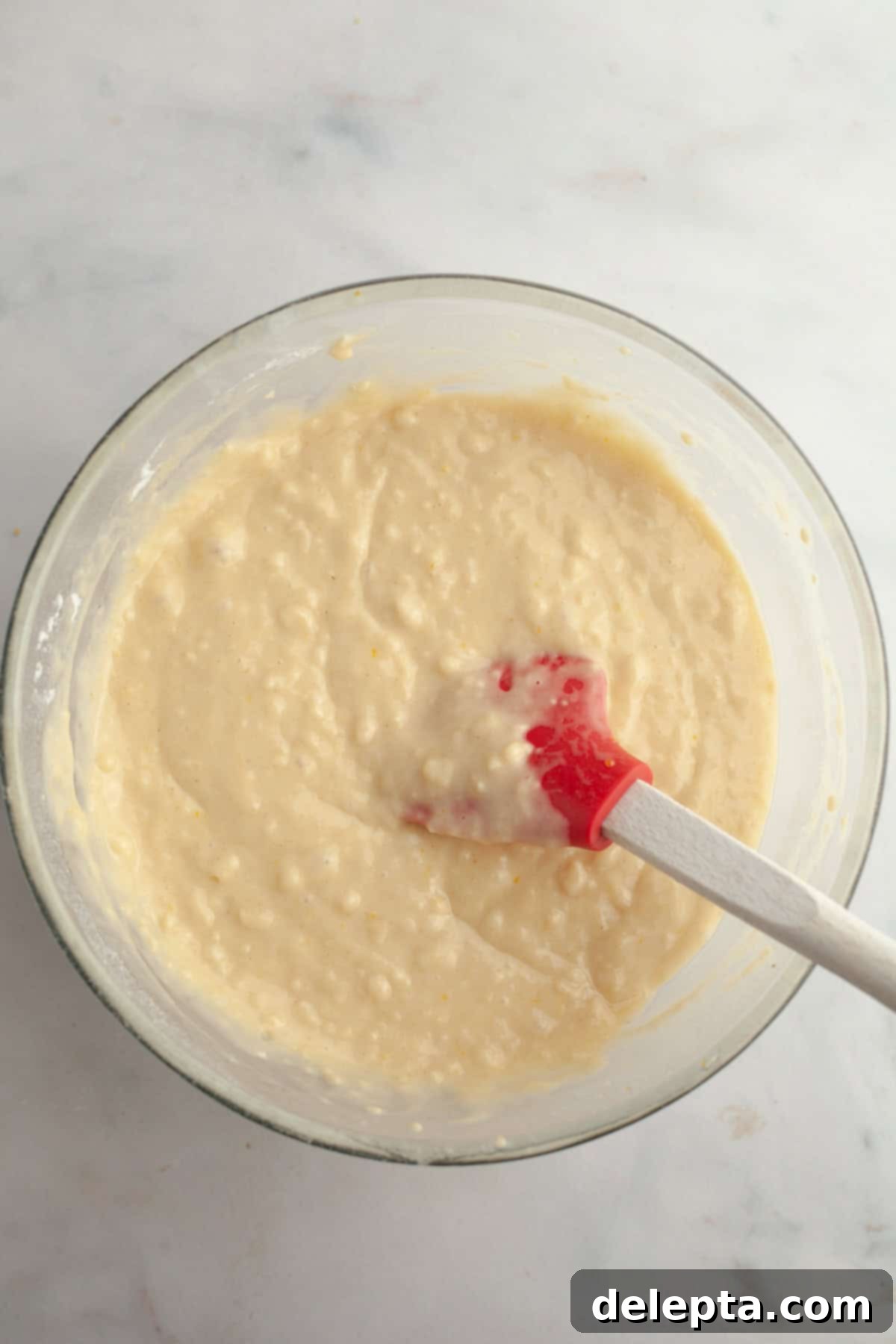 Sunny Lemon Blueberry Poppy Seed Muffins One Bowl Delight 5 Yellow muffin batter with dry ingredients just added, ready for gentle mixing with a rubber spatula.