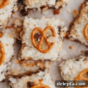 Sweet and Salty Seven Layer Pretzel Bars 7 An overhead shot of hello dolly bars on parchment paper.